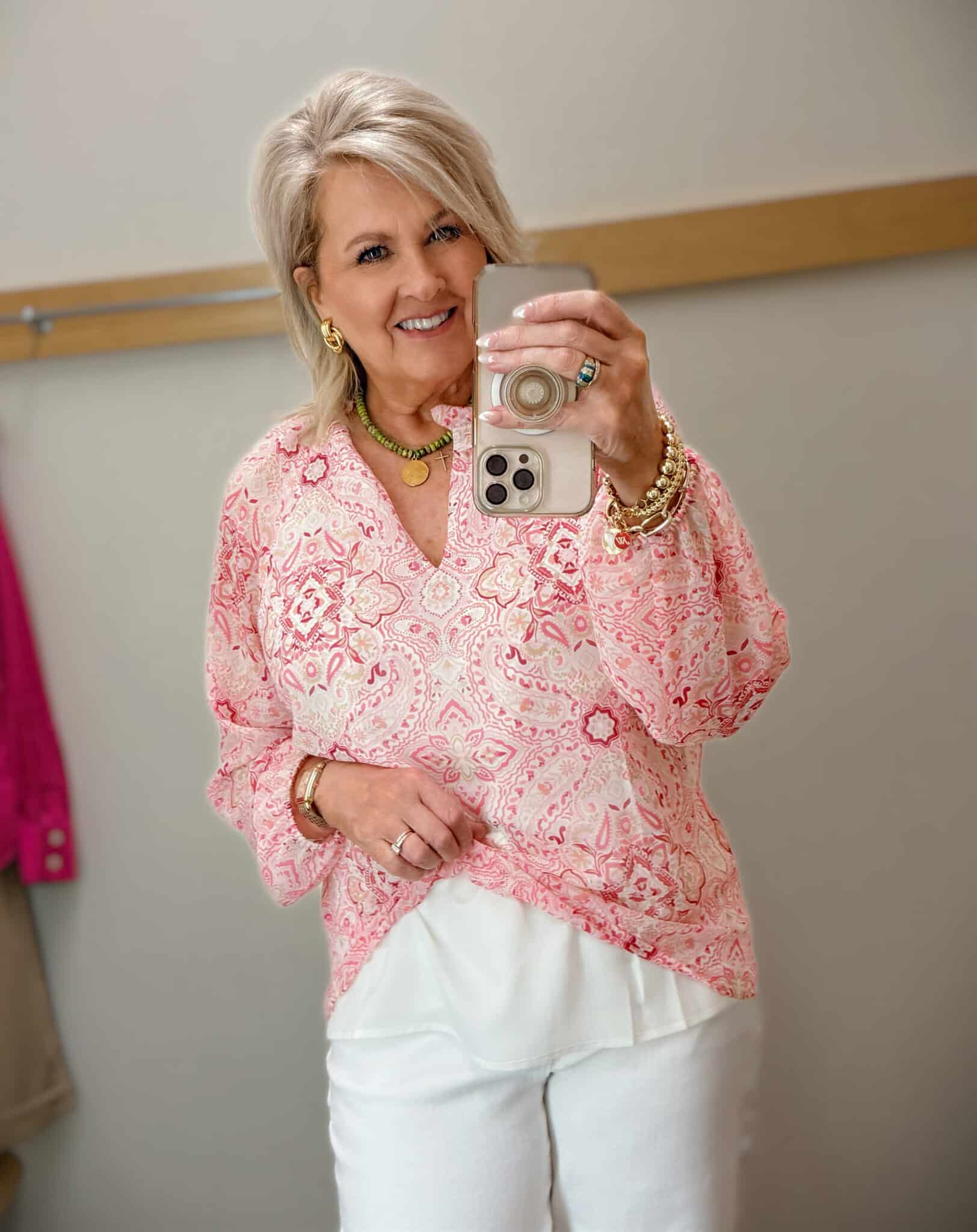 woman over 50 showing the lining of a pink paisley top from Talbots