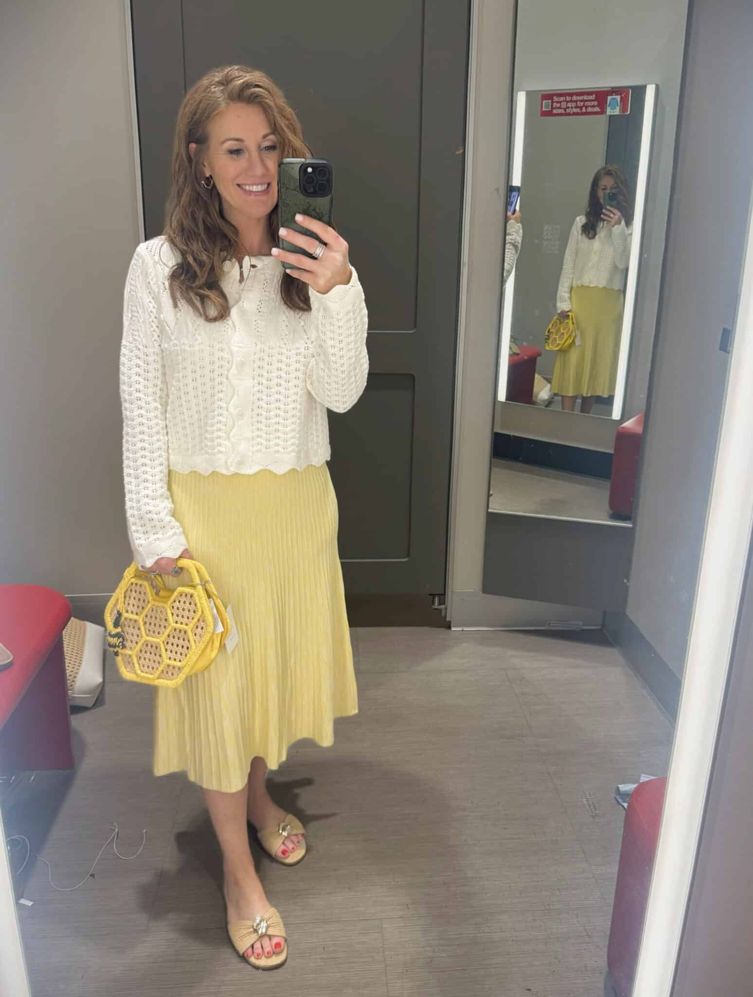 Stephanie wearing a cream cardigan and a yellow skirt from Target