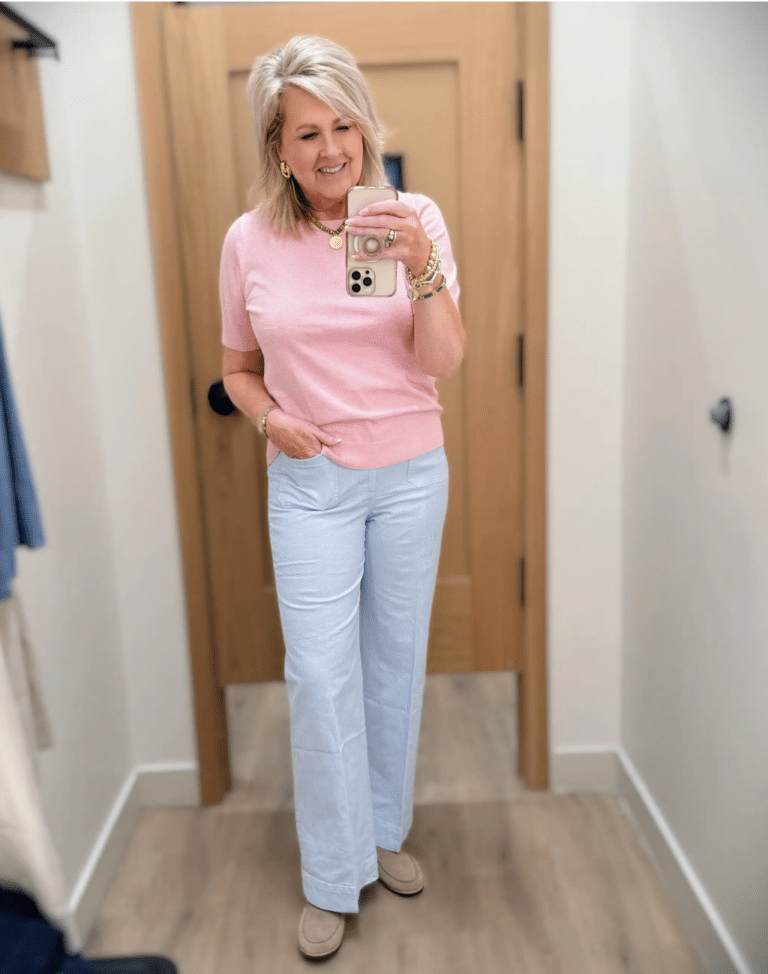 Tania wearing a pink sweater with striped light blue pants