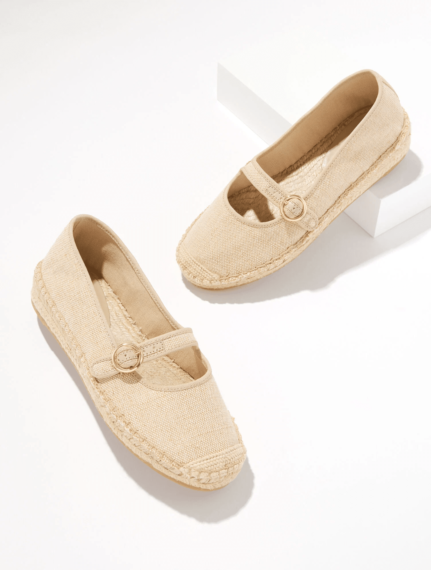 linen mary janes with a strap across them and gold buckle