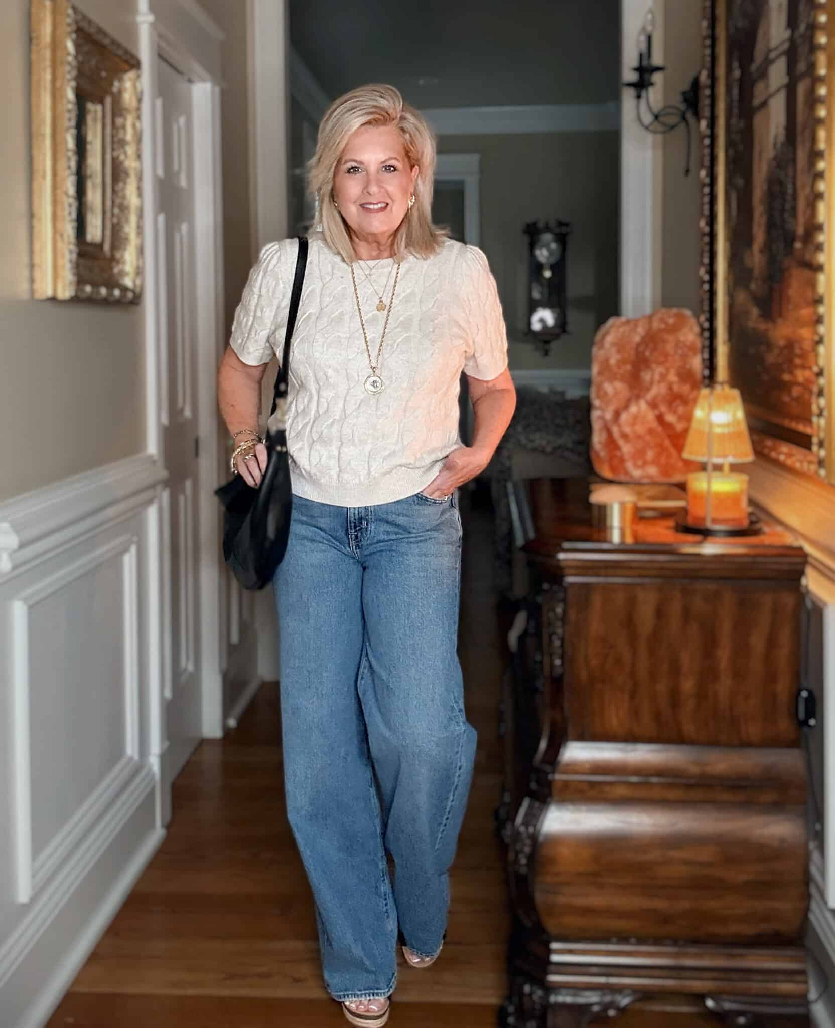 Tania wearing a cable knit cream sweater and wide leg jeans from Nordstrom