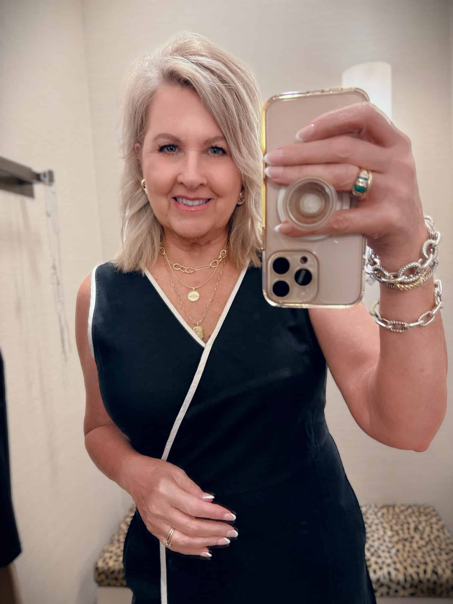 Tania wearing a Chico's black dress with a white piping detail