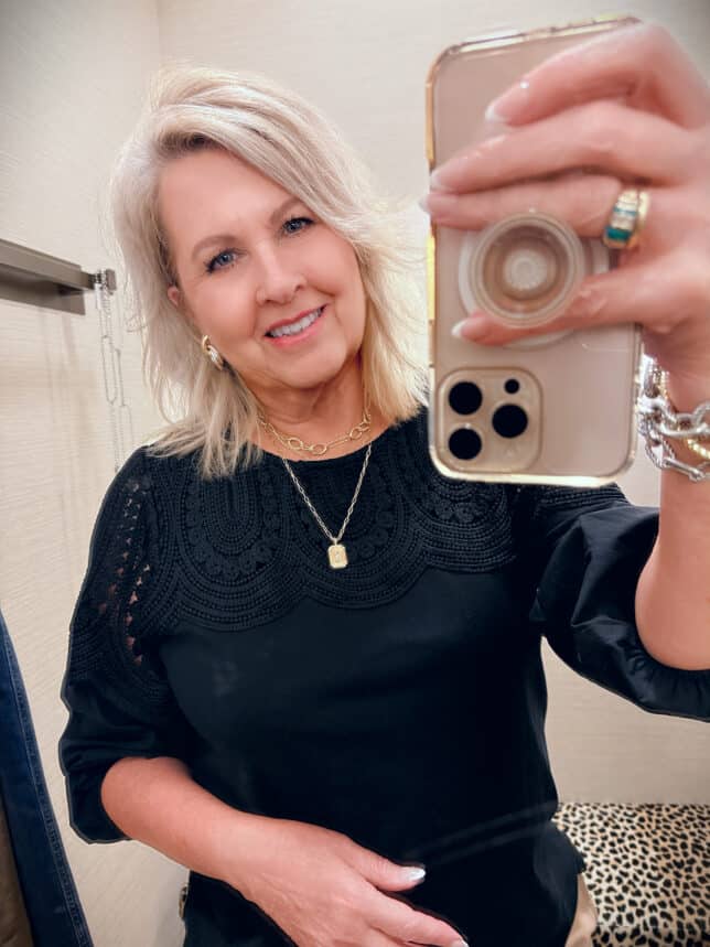 Tania wearing a Chico's black sweater with a lace detail