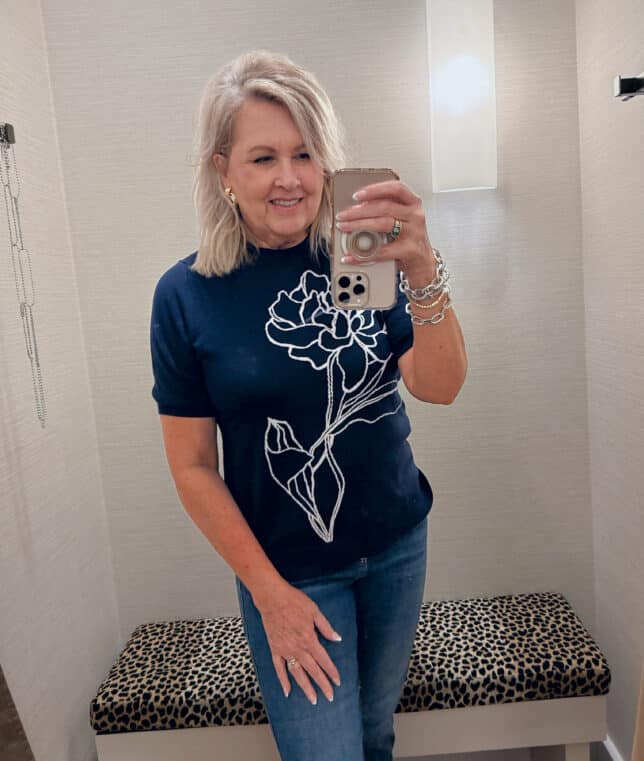 Tania wearing a Chico's navy sweater with a embroidered flower