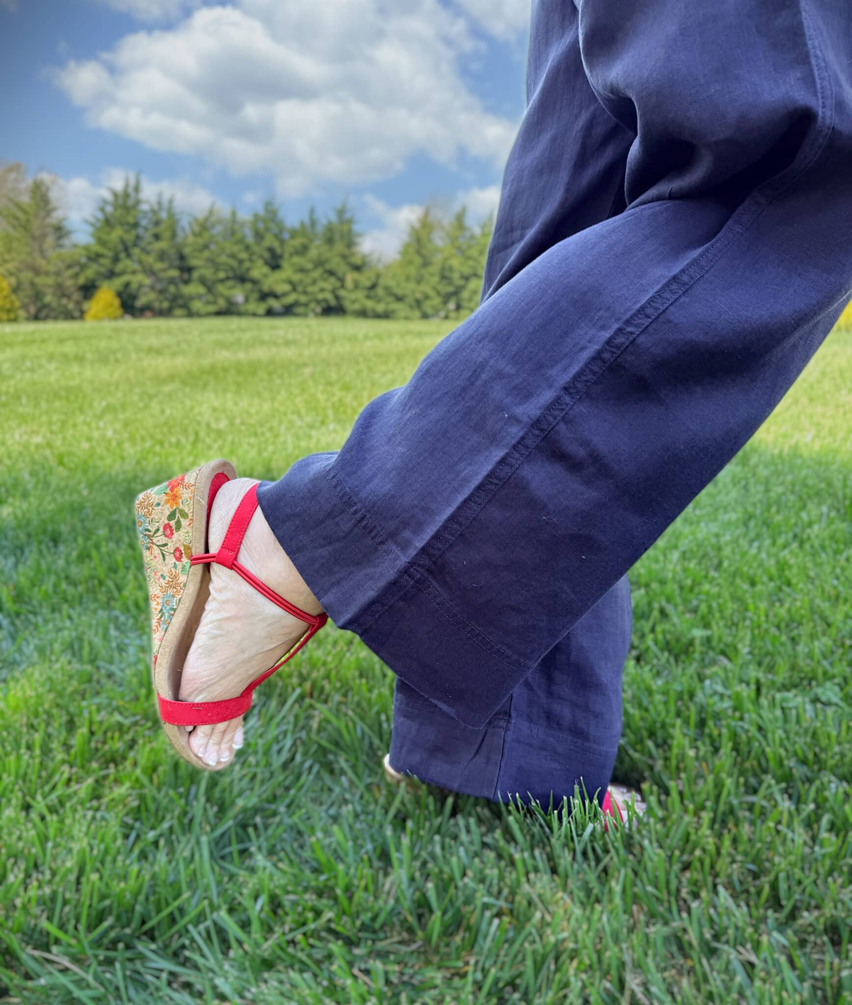 Tania wearing navy linen pants and red wedge heels from Macy's