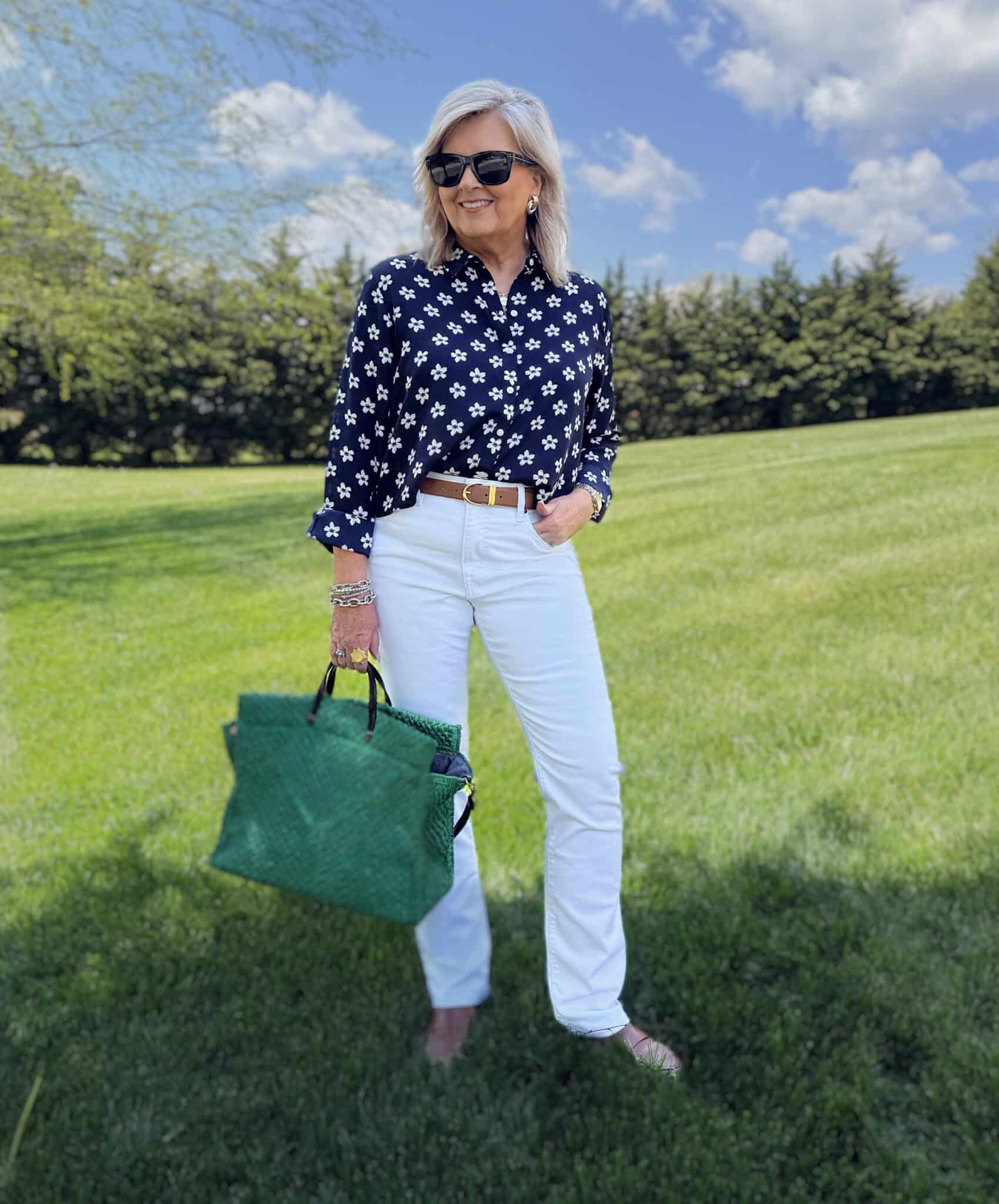 Tania wearing a navy & white floral button up shirt and white jeans from Macy's