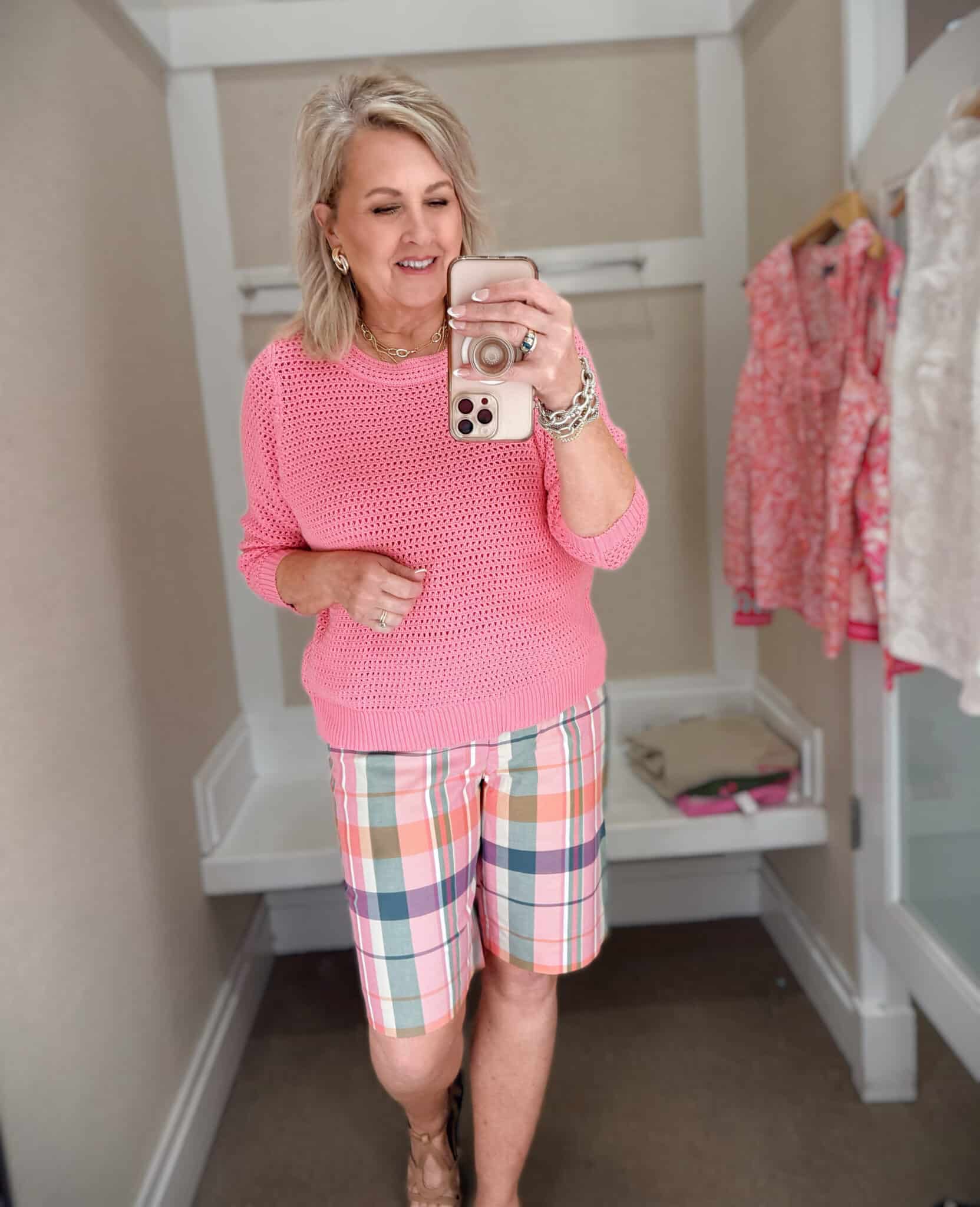 Tania wearing a pink open stitch sweater with madras shorts from Talbots