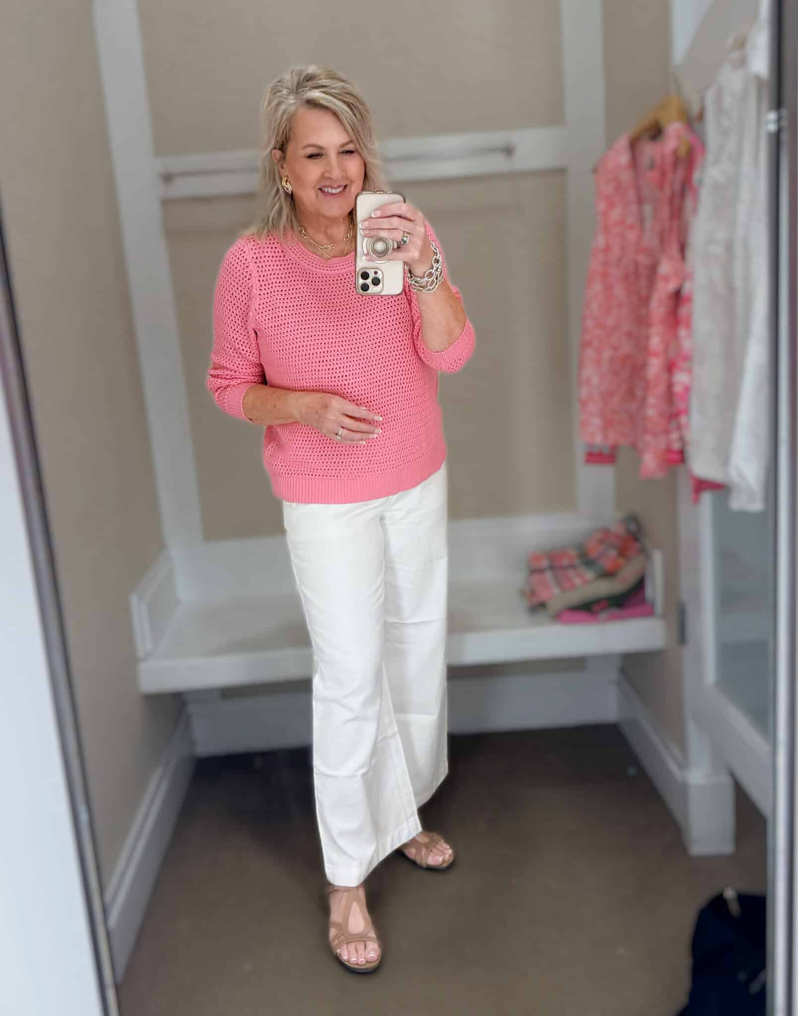 Tania wearing a pink open stitch sweater with white wide leg pants from Talbots