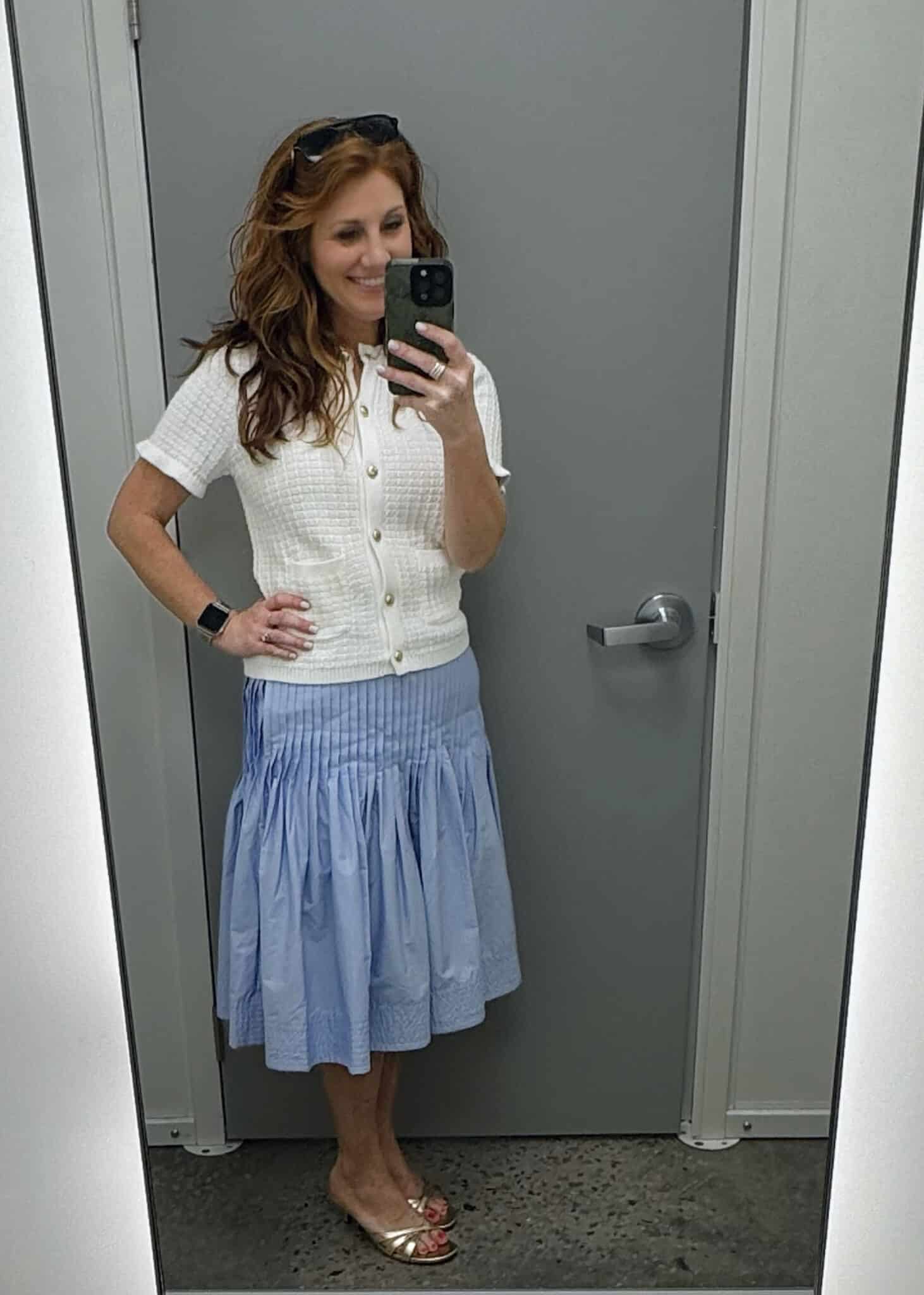 Stephanie wearing a button cardigan sweater with a striped skirt from Walmart