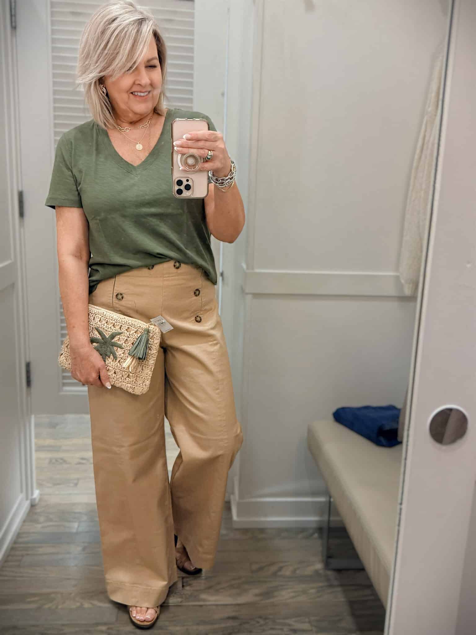 Tania wearing an olive v-neck tee with tan sailor pants from Loft