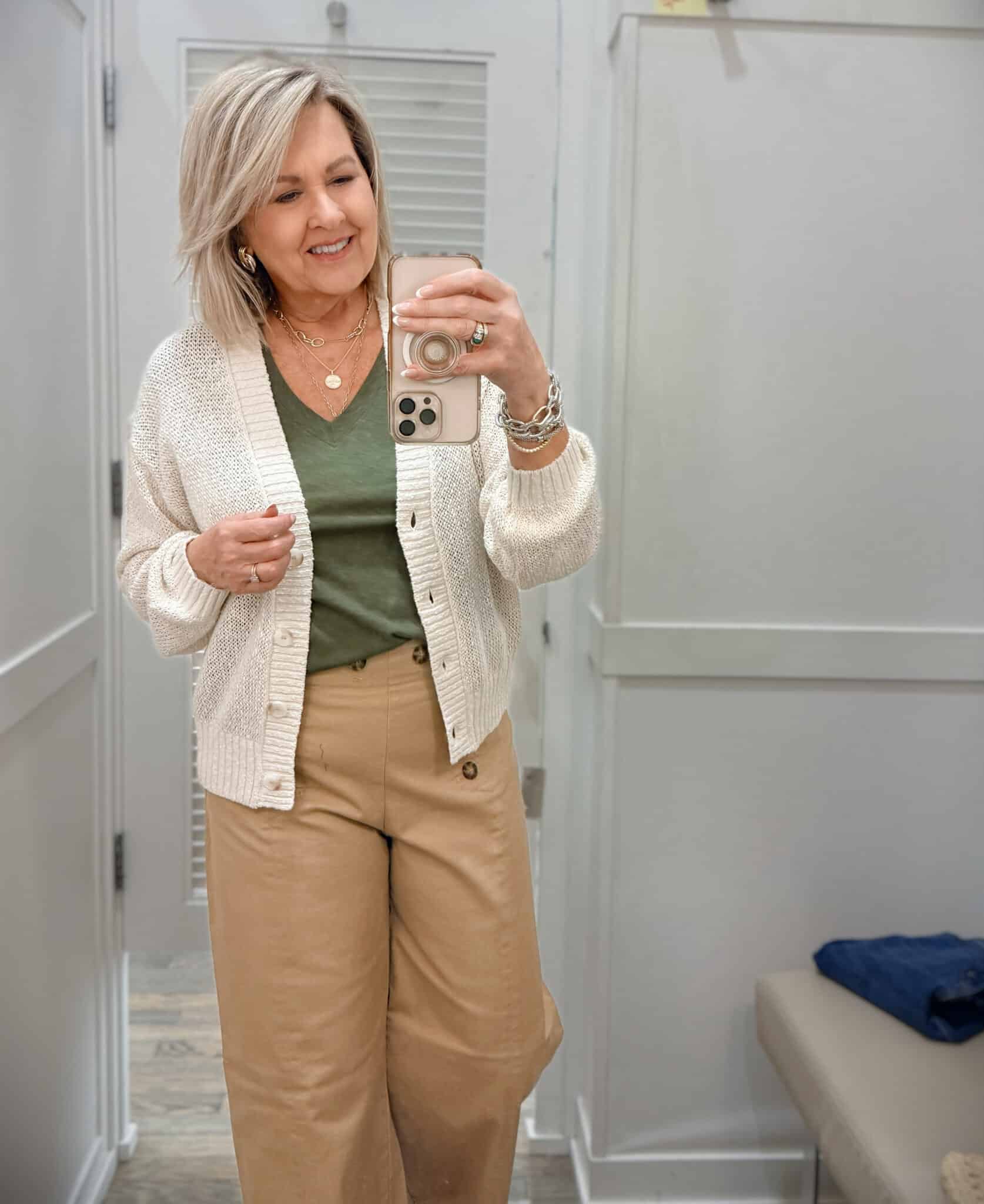 Tania wearing an olive v-neck tee and a cardigan with tan sailor pants from Loft