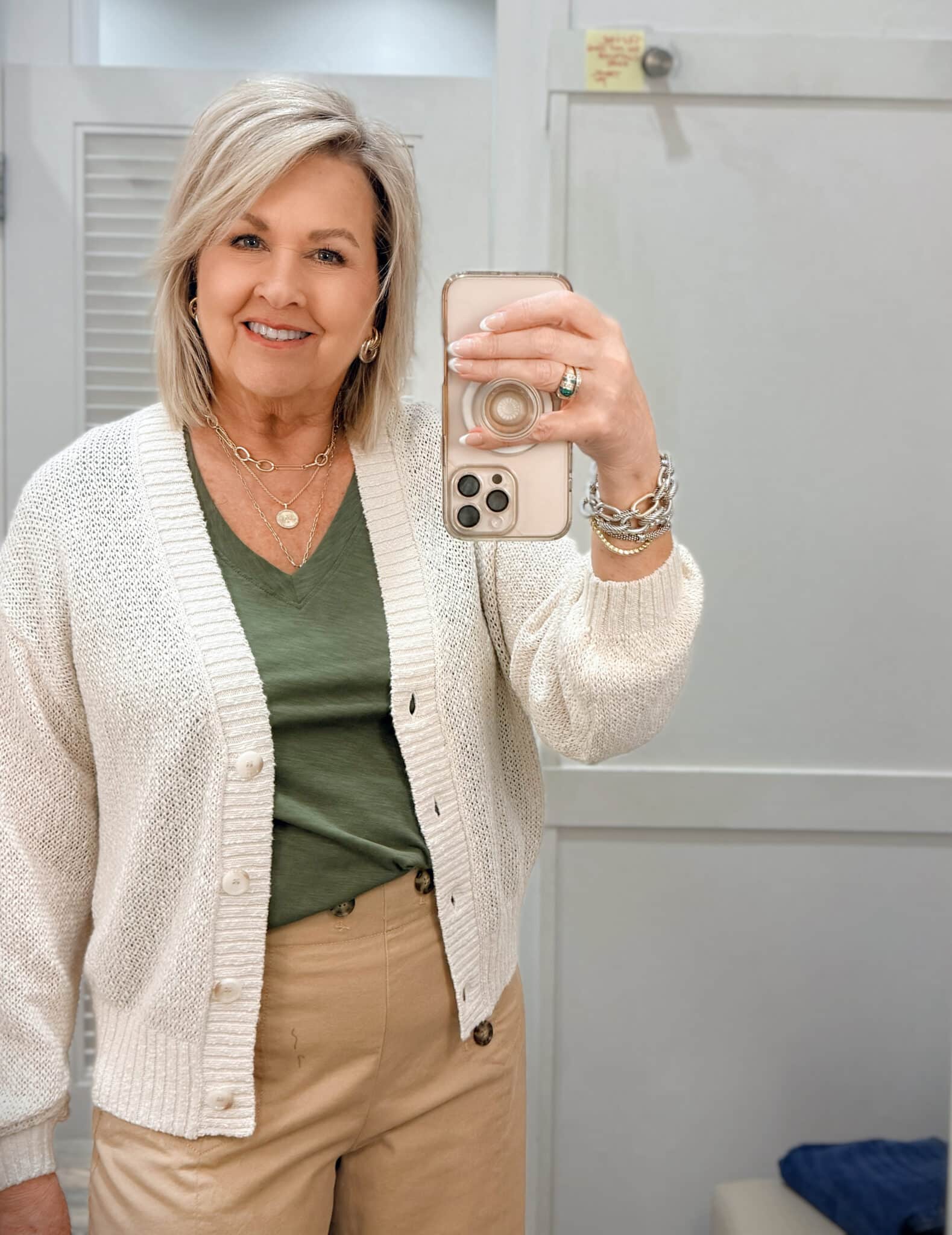 Tania wearing an olive v-neck tee with a beige cardigan from Loft