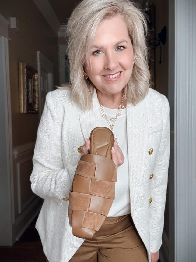 Tania holding a pair of Kenneth Cole Fisherman sandals.