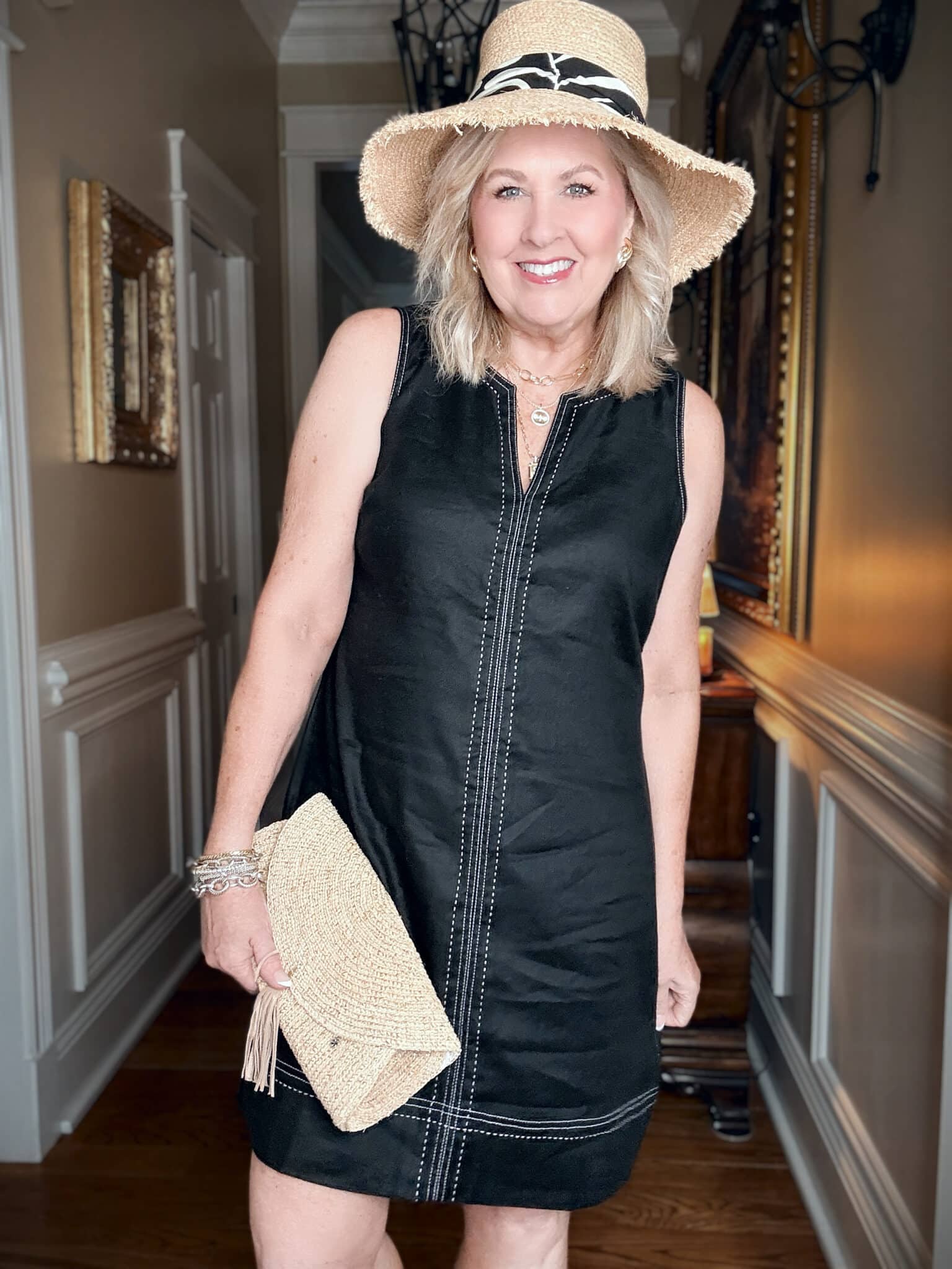 Tania wearing a Tommy Bahama vacation outfit of a black sheath dress