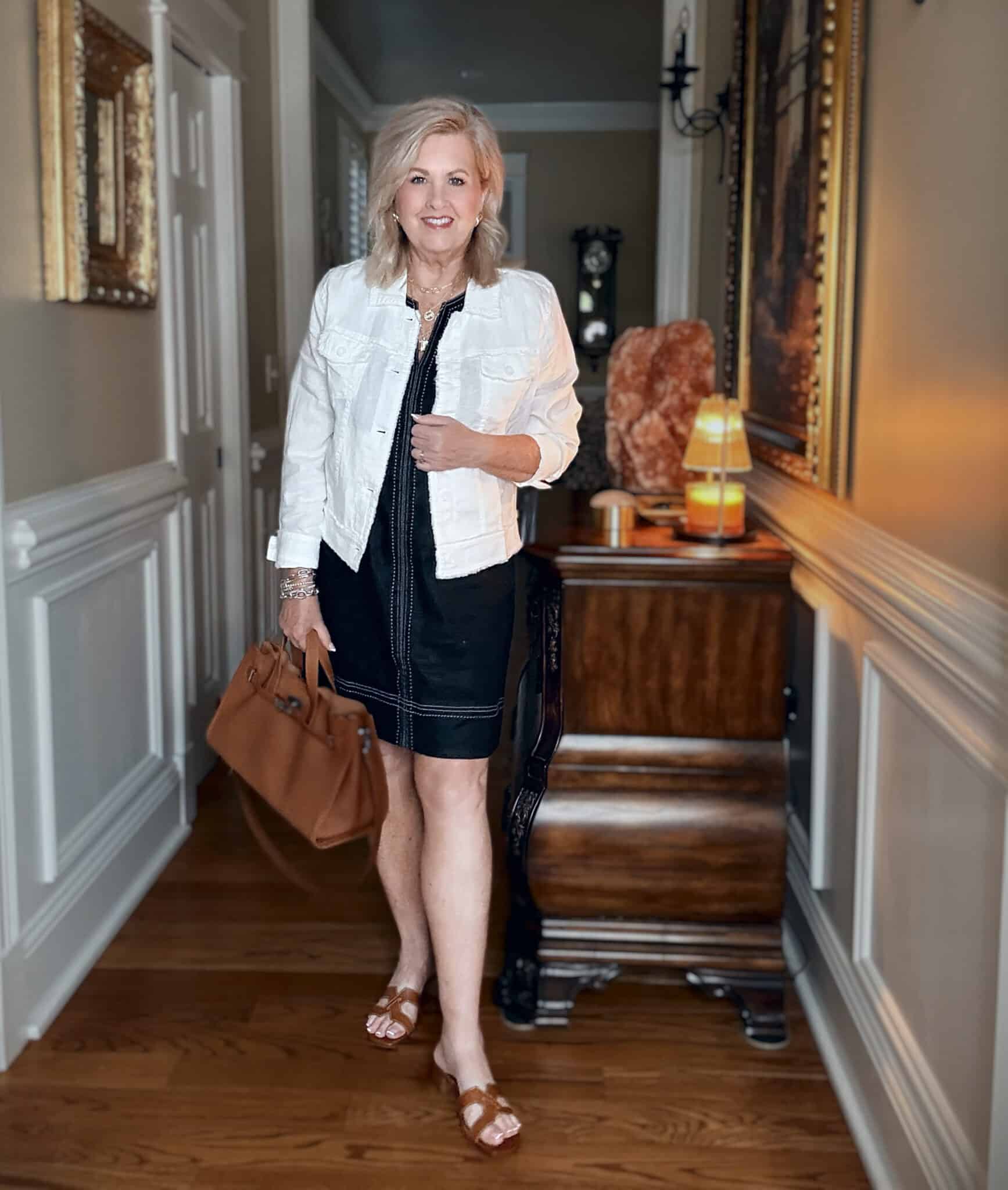 Tania wearing a Tommy Bahama vacation outfit of a sheath dress with a linen jacket
