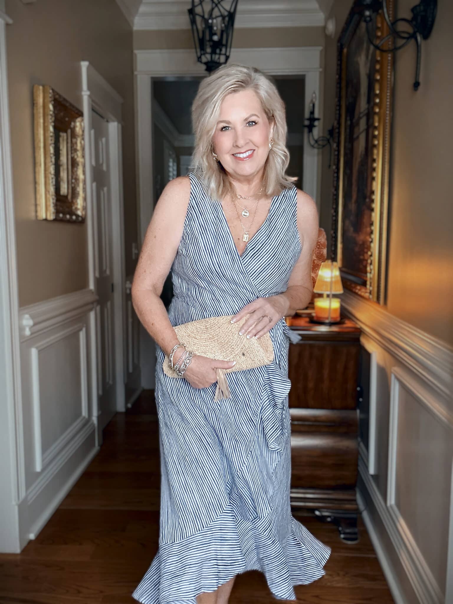 Tania wearing a Tommy Bahama blue striped wrap dress for vacation