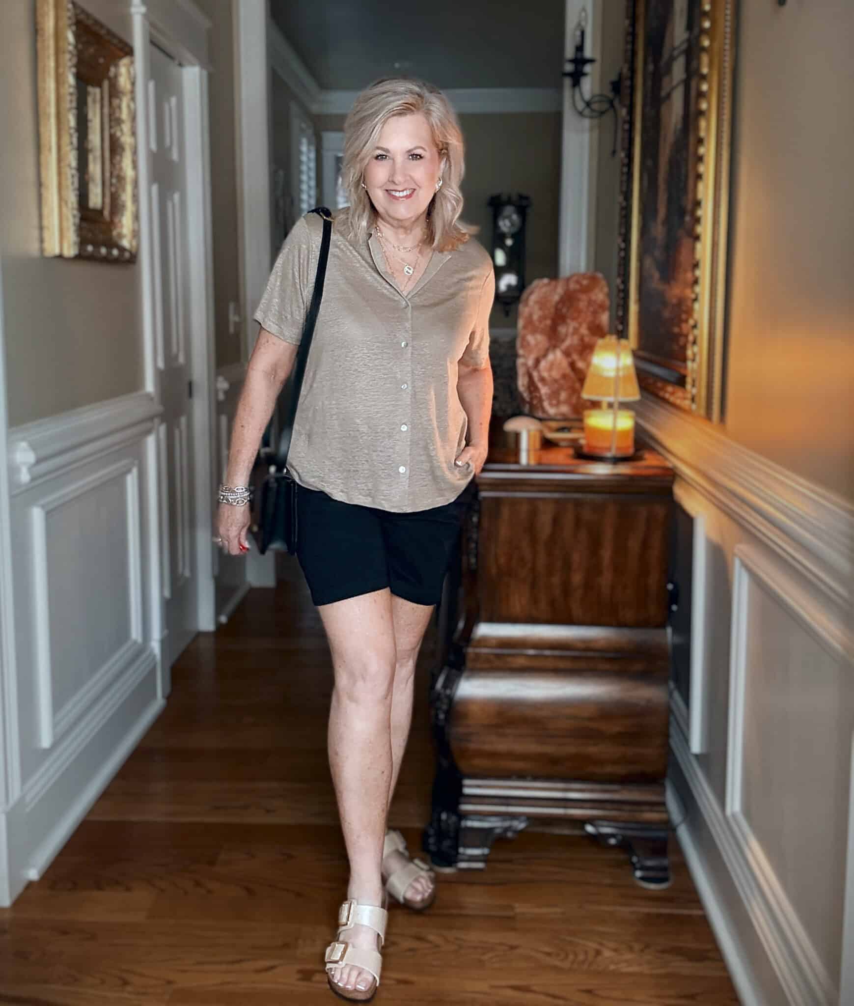 Tania wearing a Tommy Bahama tan linen button up shirt with black shorts for a vacation outfit