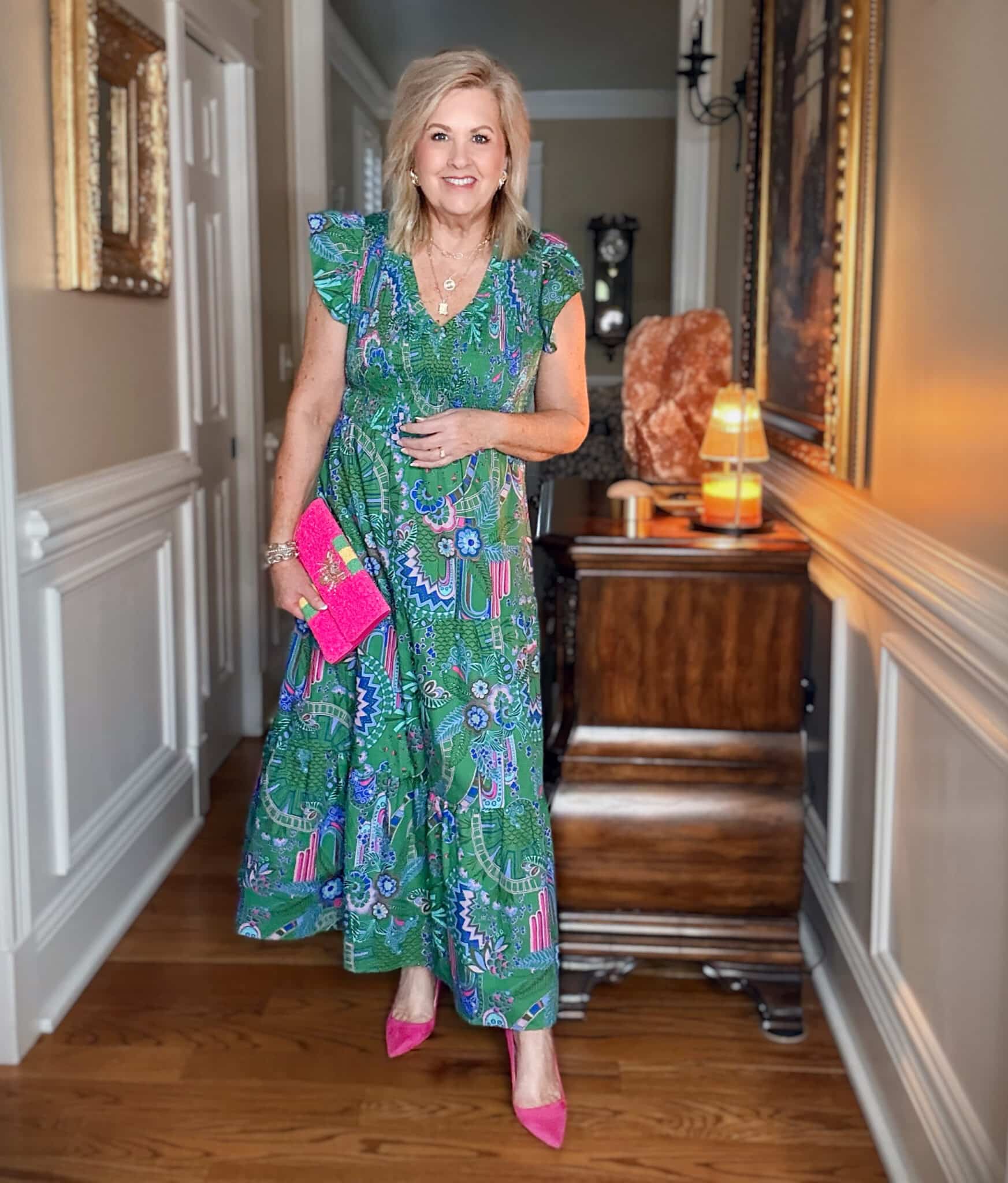 Tania wearing a flutter sleeve multi color green maxi dress by SUGARLIPS