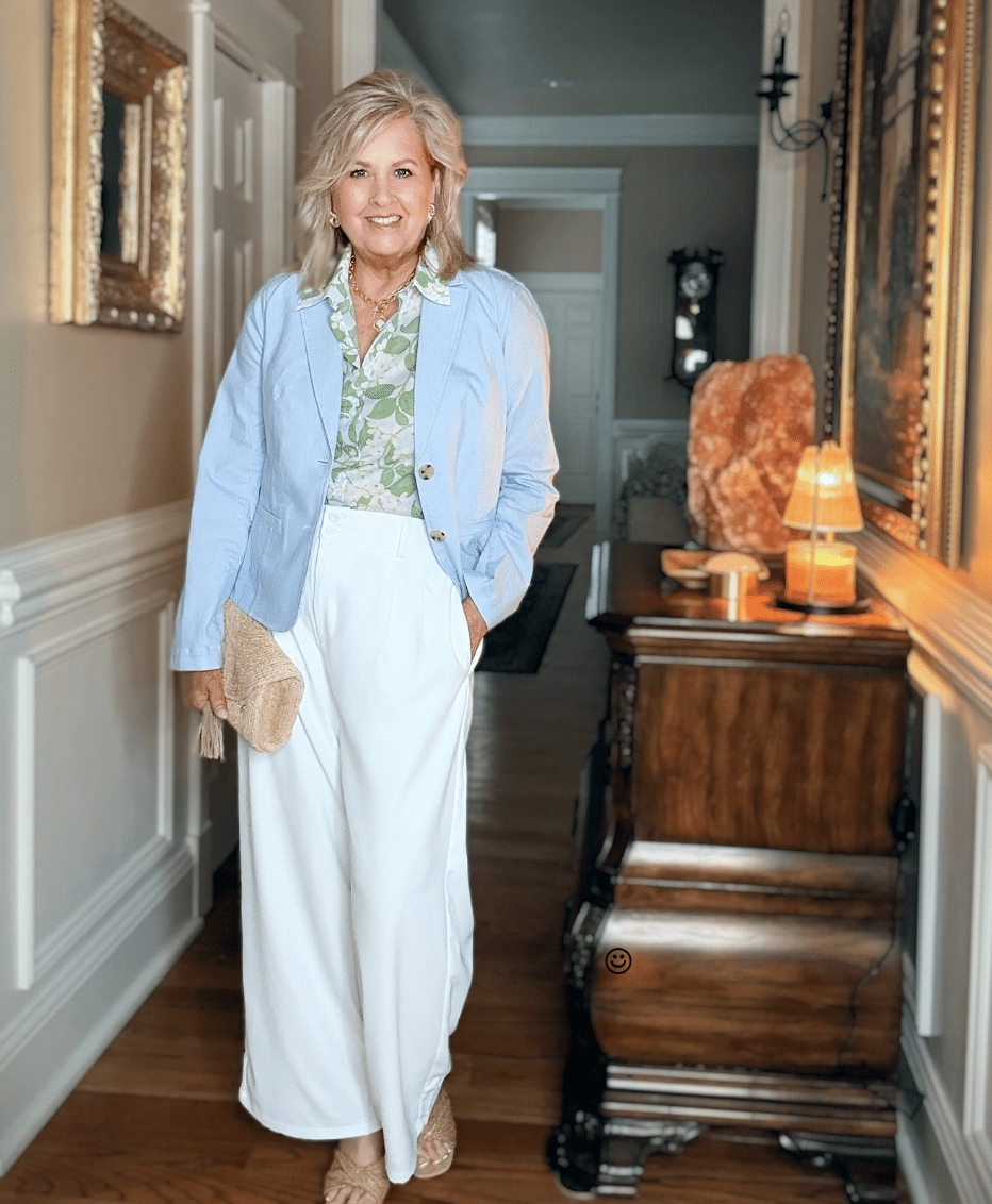 Adding structure to look put-together after 50. Tania Stephens wearing a light blue blazer over a green floral top