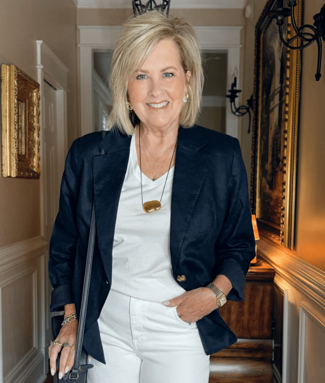 Tania wearing a V-neck white shirt with a navy blazer