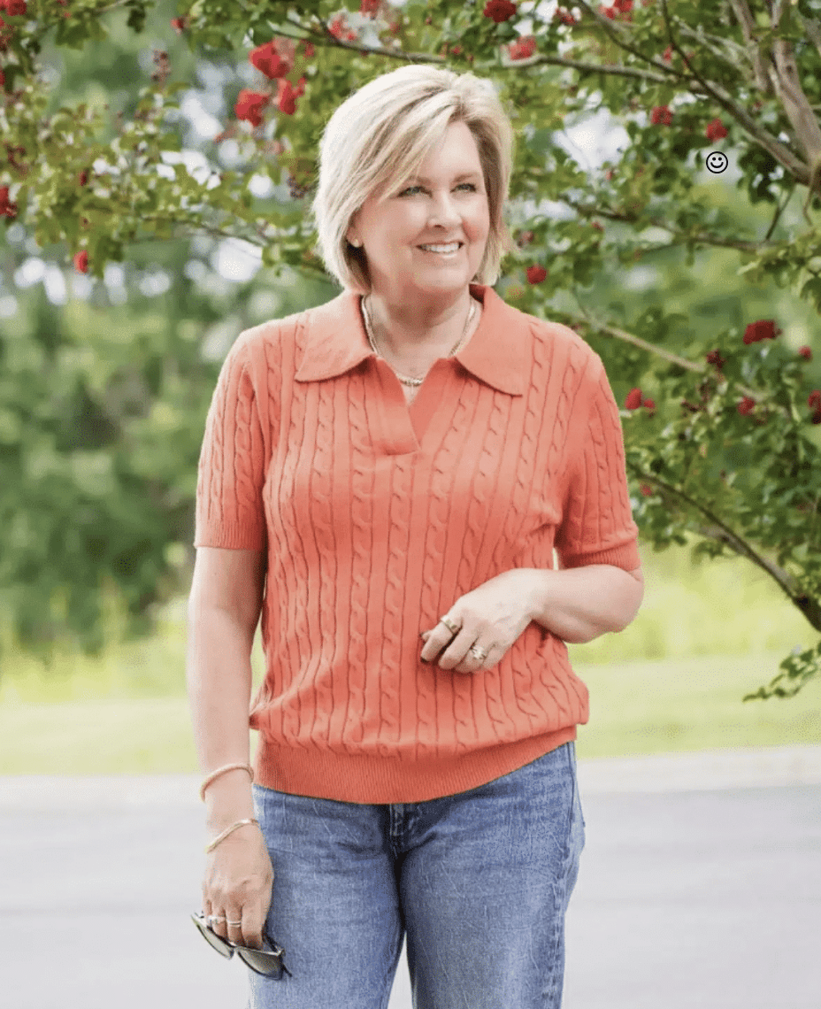 An Amazon short sleeve cableknit polo sweater paired with jeans on a woman