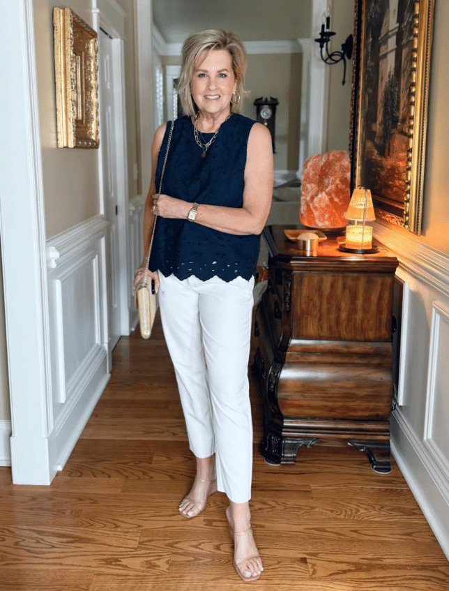 Tania wearing a navy eyelet top with white pants from Athleta