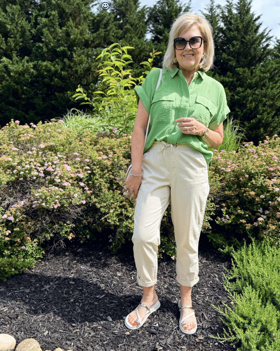 TANIA WEARING a green camp shirt and beige CROPPED PANTS