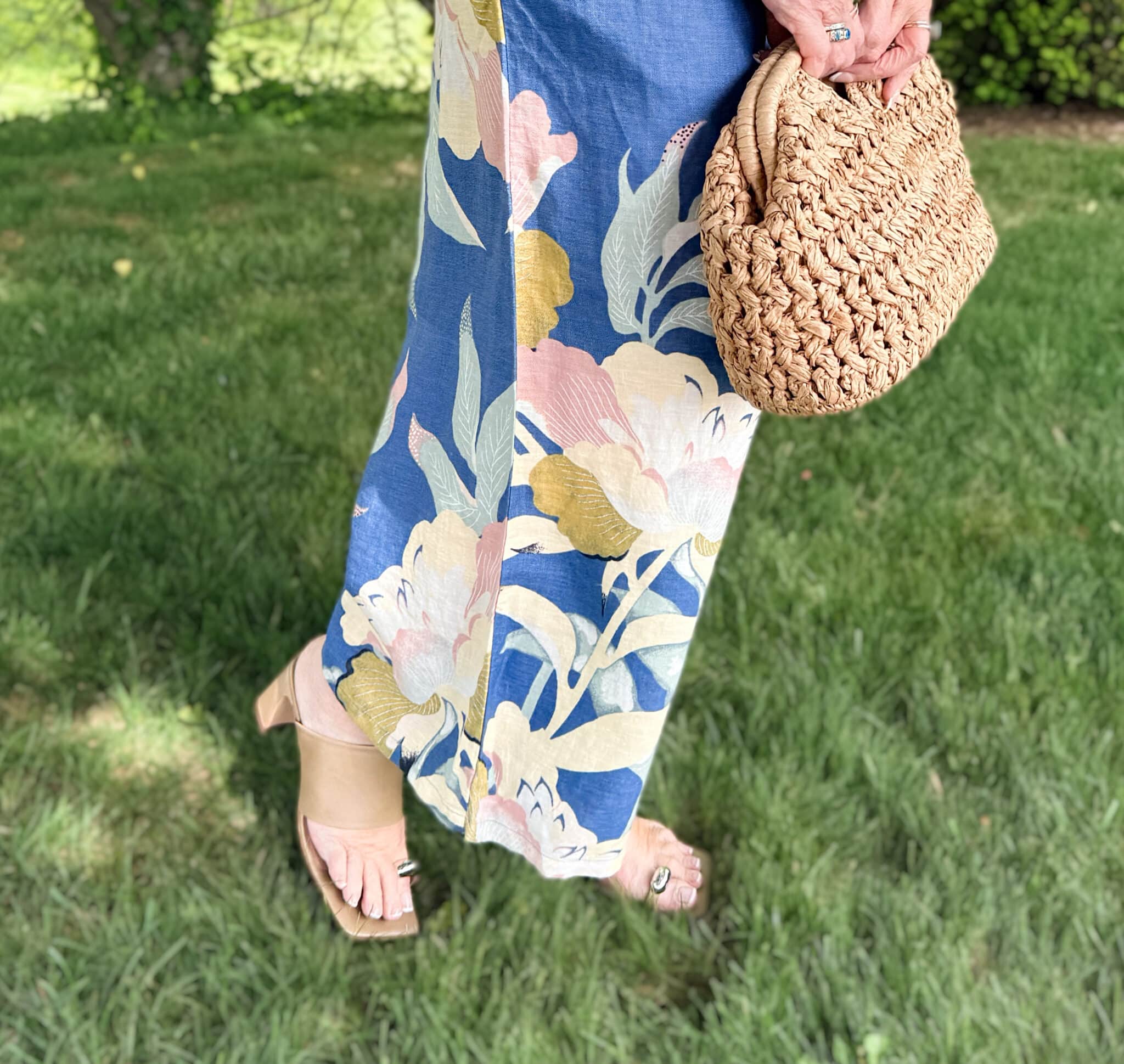 Tania wearing floral linen pants with toe loop sandals from Anthrpologie