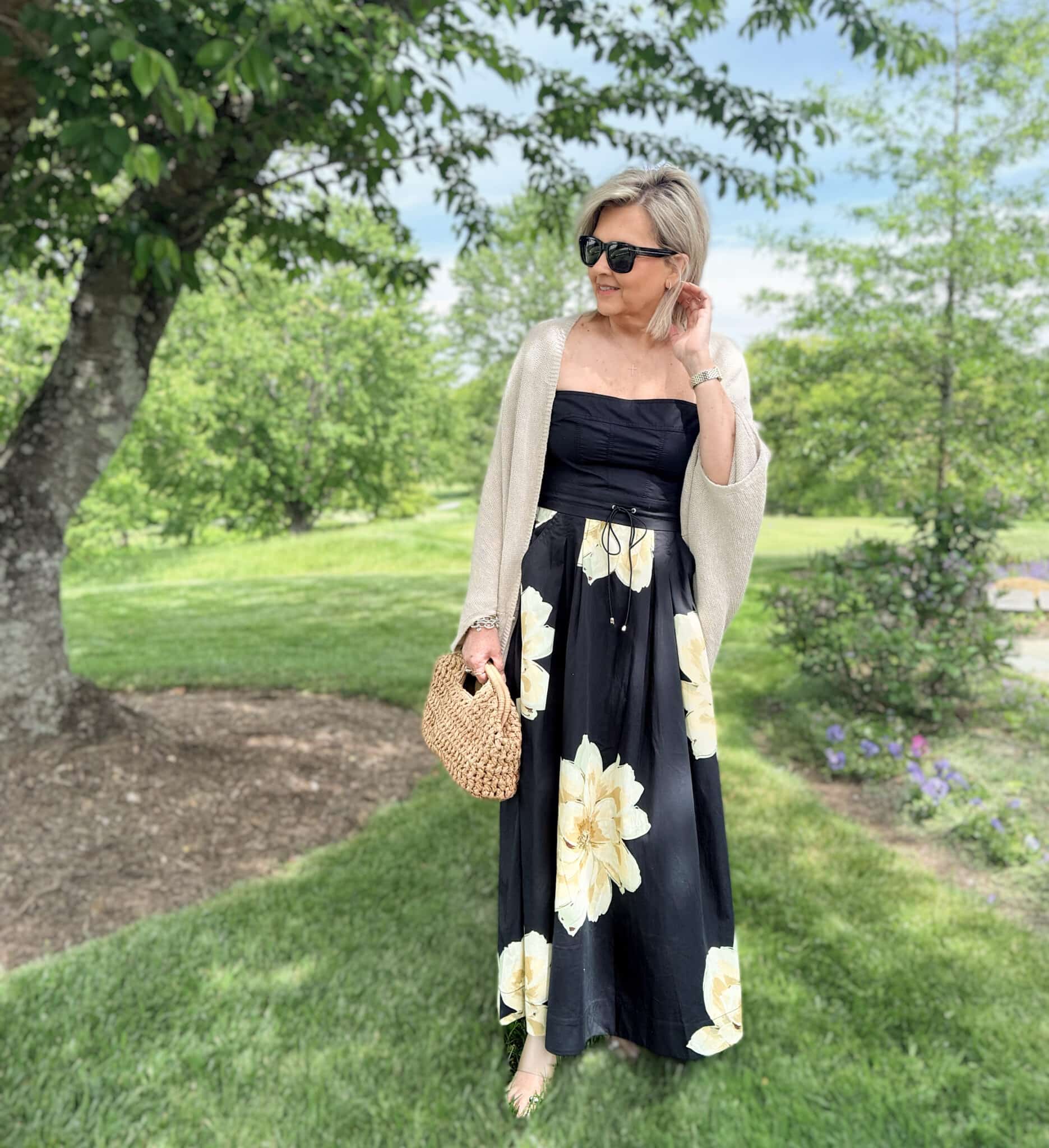Tania wearing a black dress with flowers from Anthrpologie and a shrug for cool nights