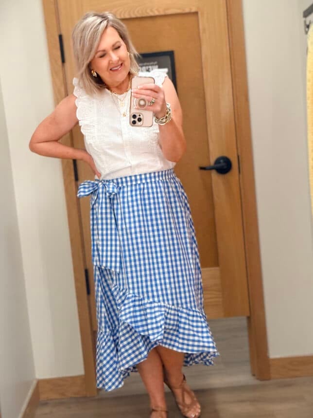 Tania wearing a white ruffle sleeve top with a gingham wrap skirt from J.Crew Factory