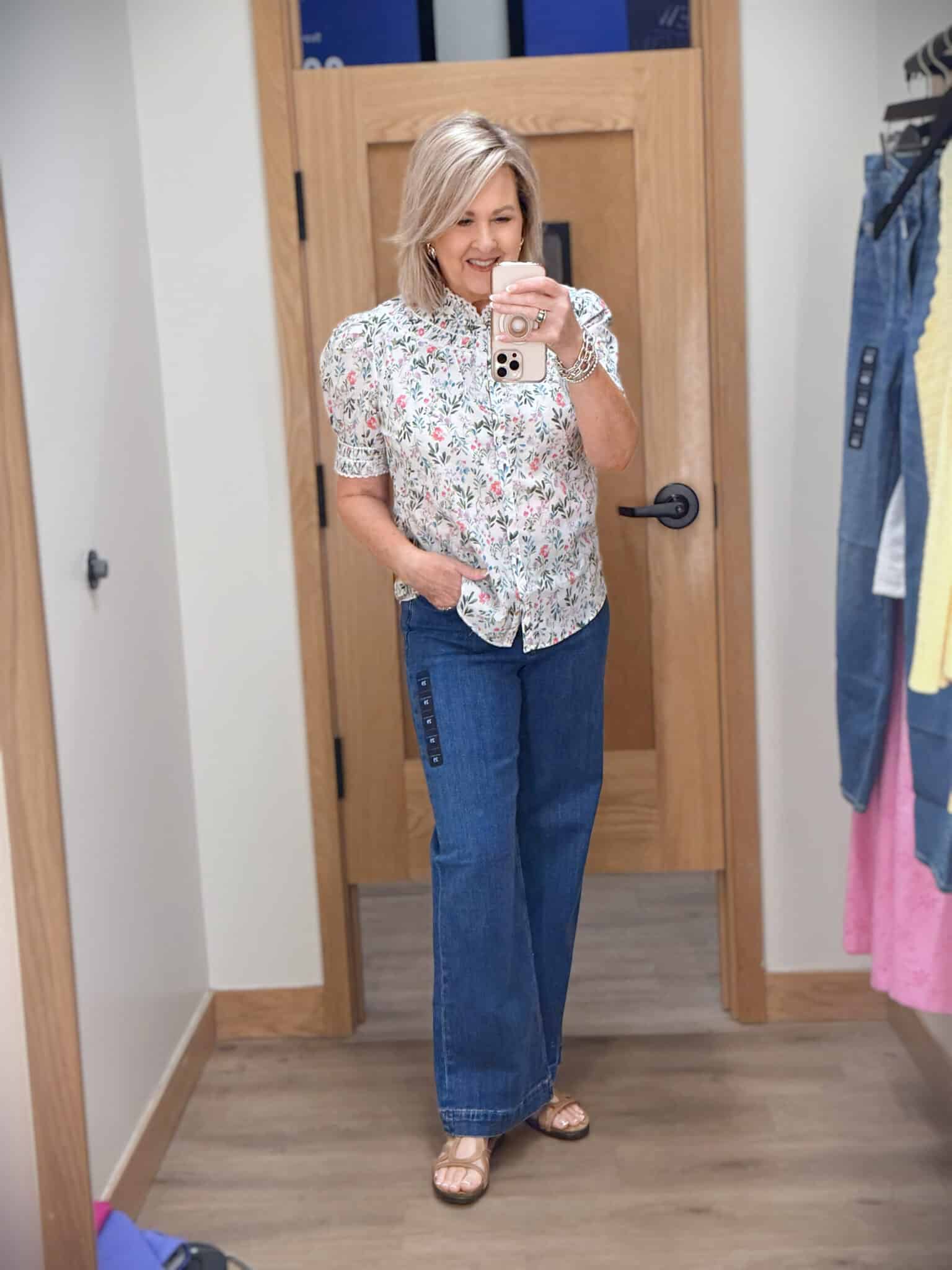 Tania wearing a floral puff sleeve top with a pair of wide leg jeans from J.Crew Factory