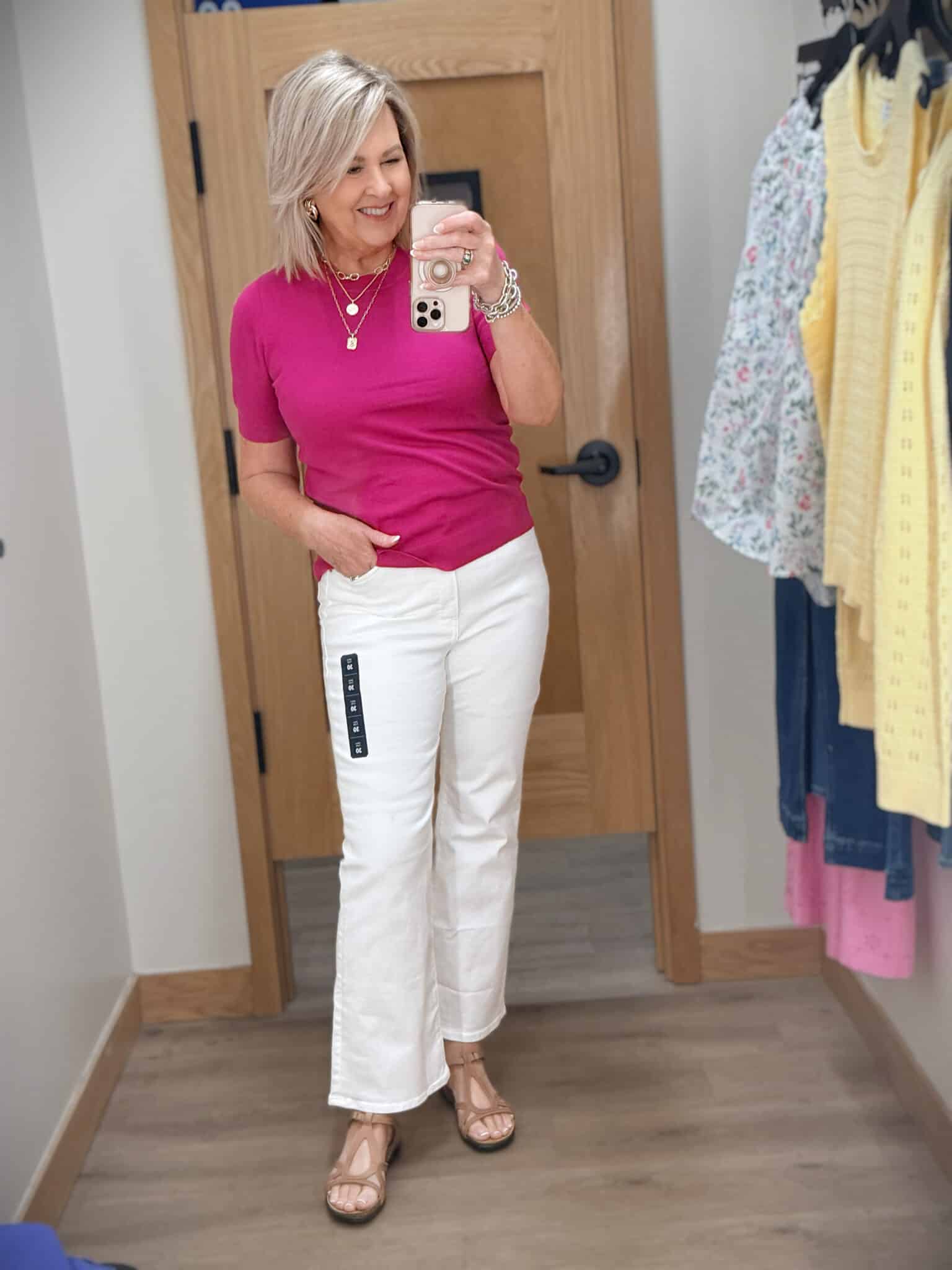 Tania wearing a dark fuchsia sweater with a pair of white jeans from J.Crew Factory