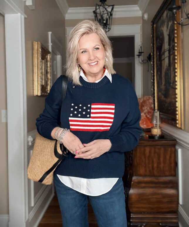Tania wearing a white shirt with a navy American flag sweater