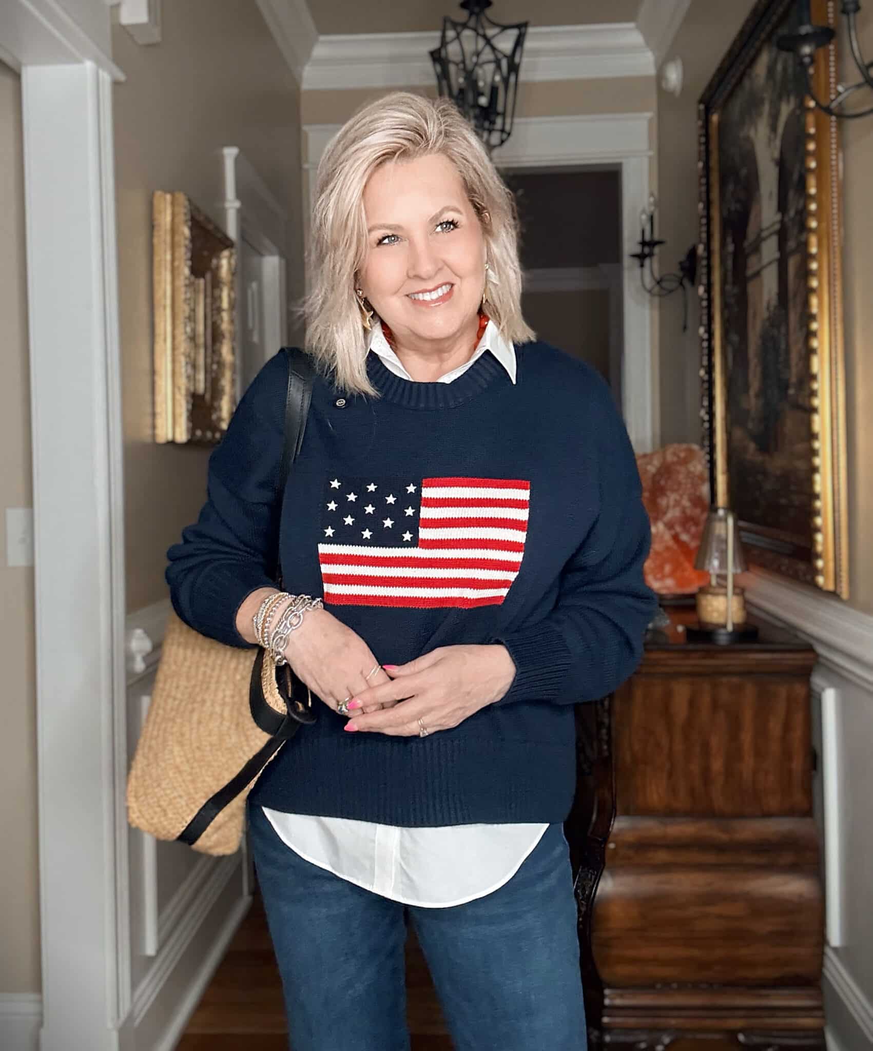 Tania wearing a white shirt with a navy American flag sweater