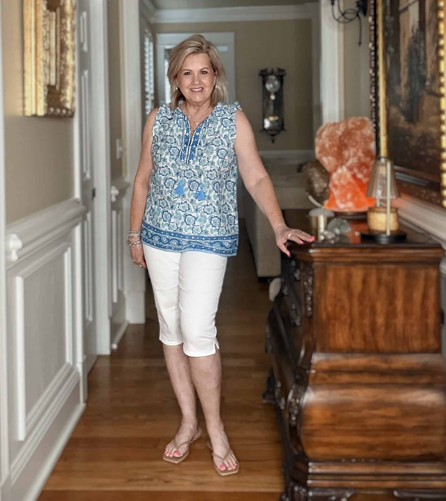 Tania wearing a printed blue lightweight shirt with white capris