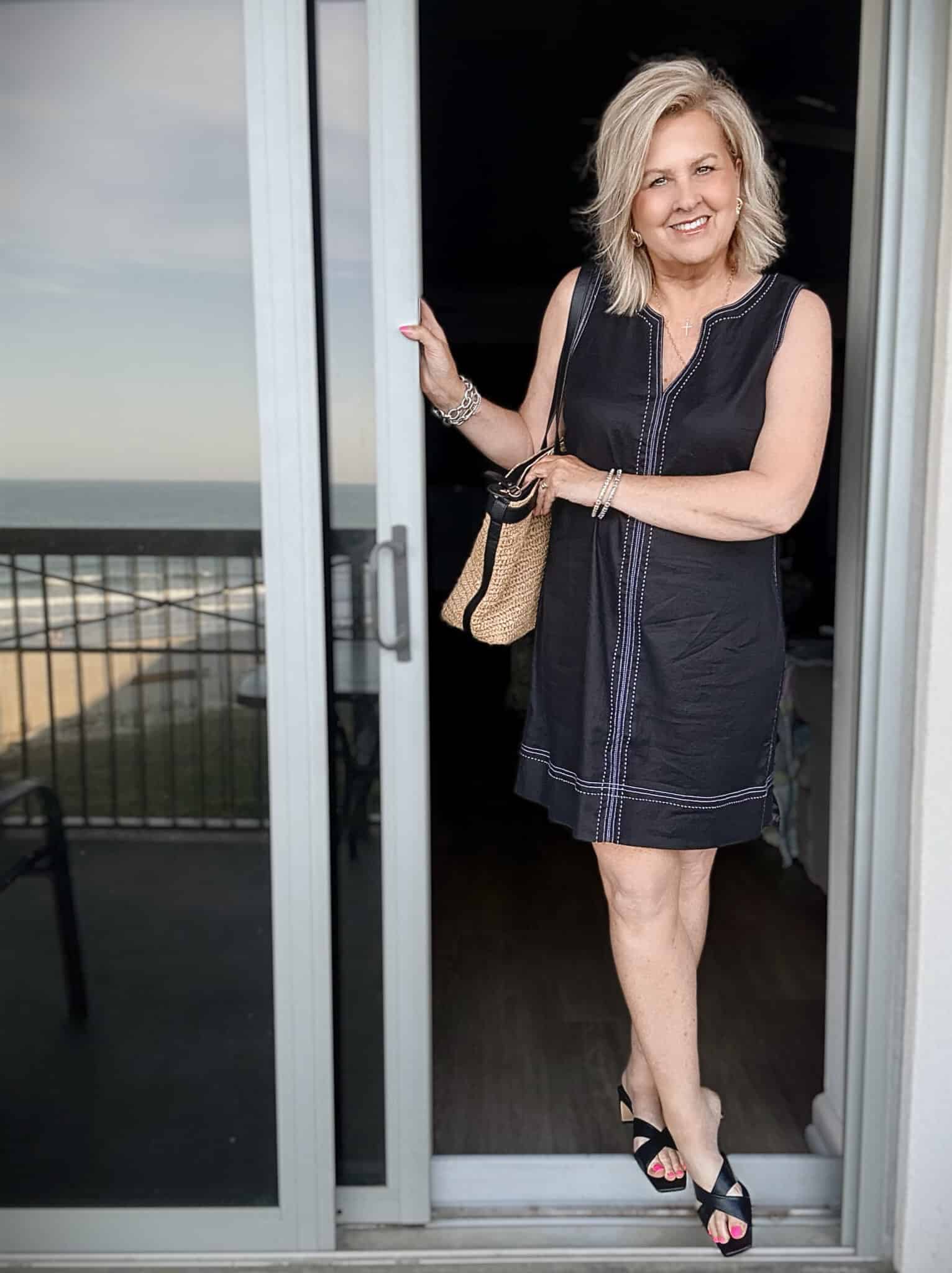 Tania wearing a Tommy Bahama black sheath dress at the beach