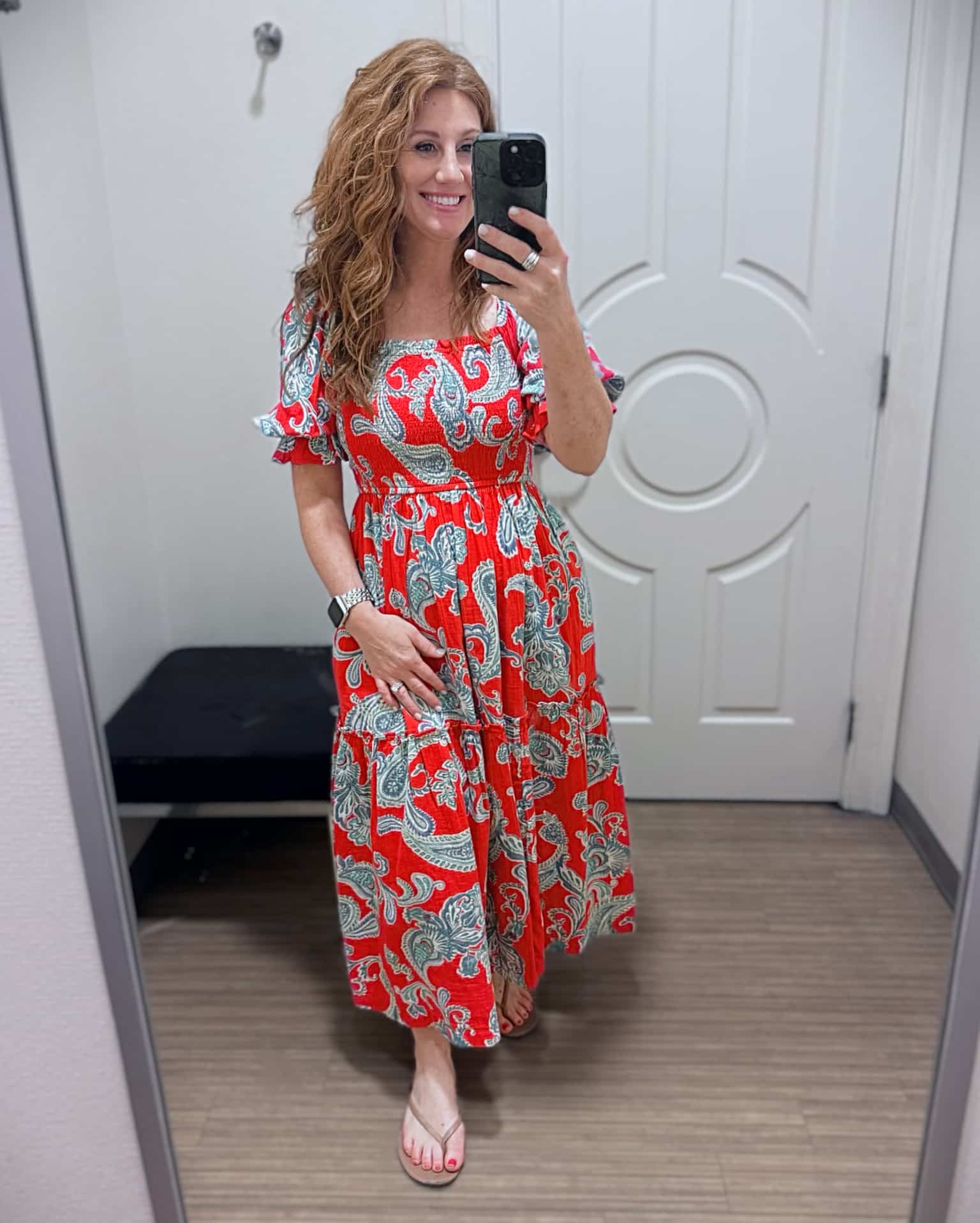 Stephanie wearing a red paisley print smocked maxi dress from Belk with neutral thong sandals from Walmart.