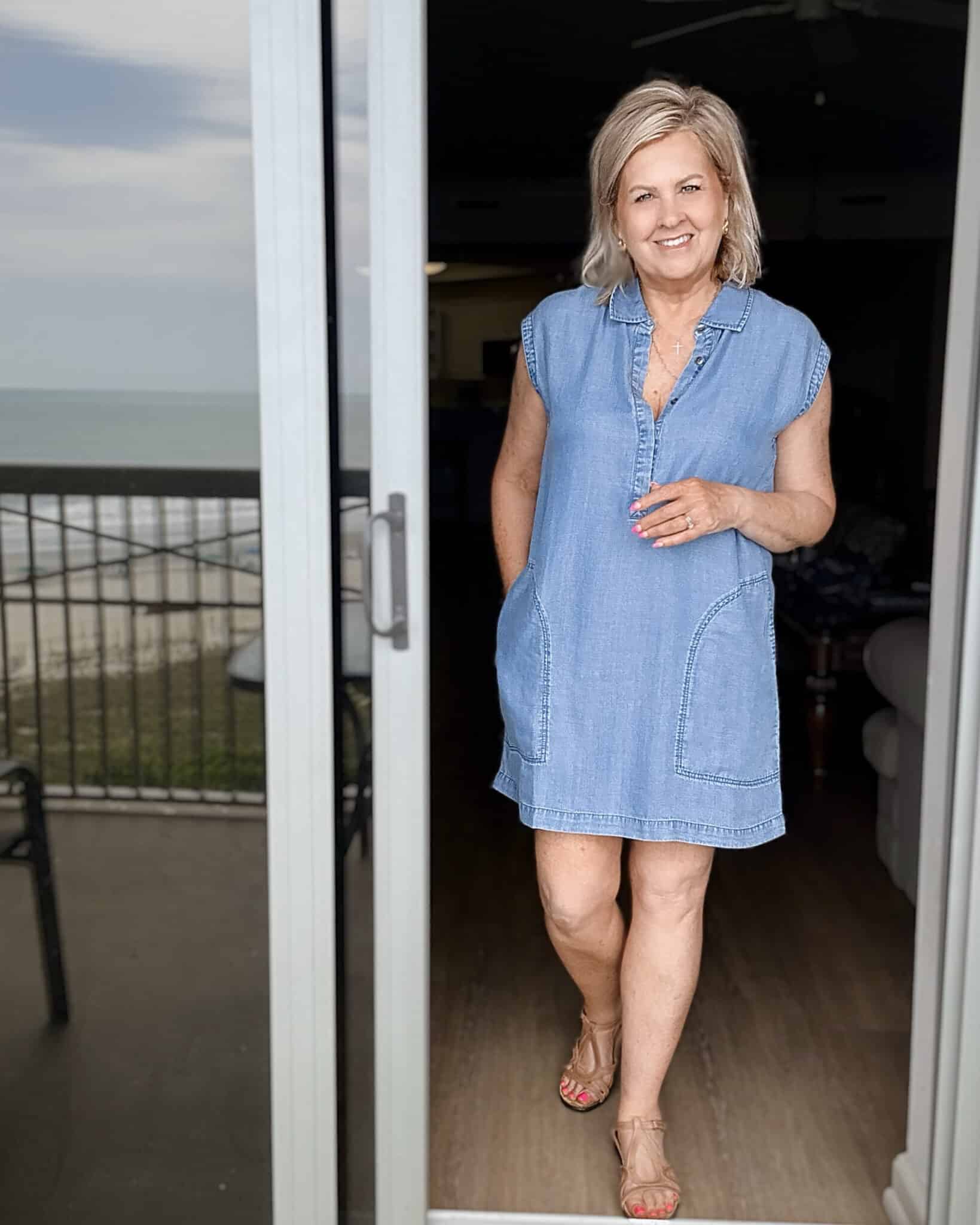Tania wearing a short sleeveless chambray mini dress with cork sandals for summer