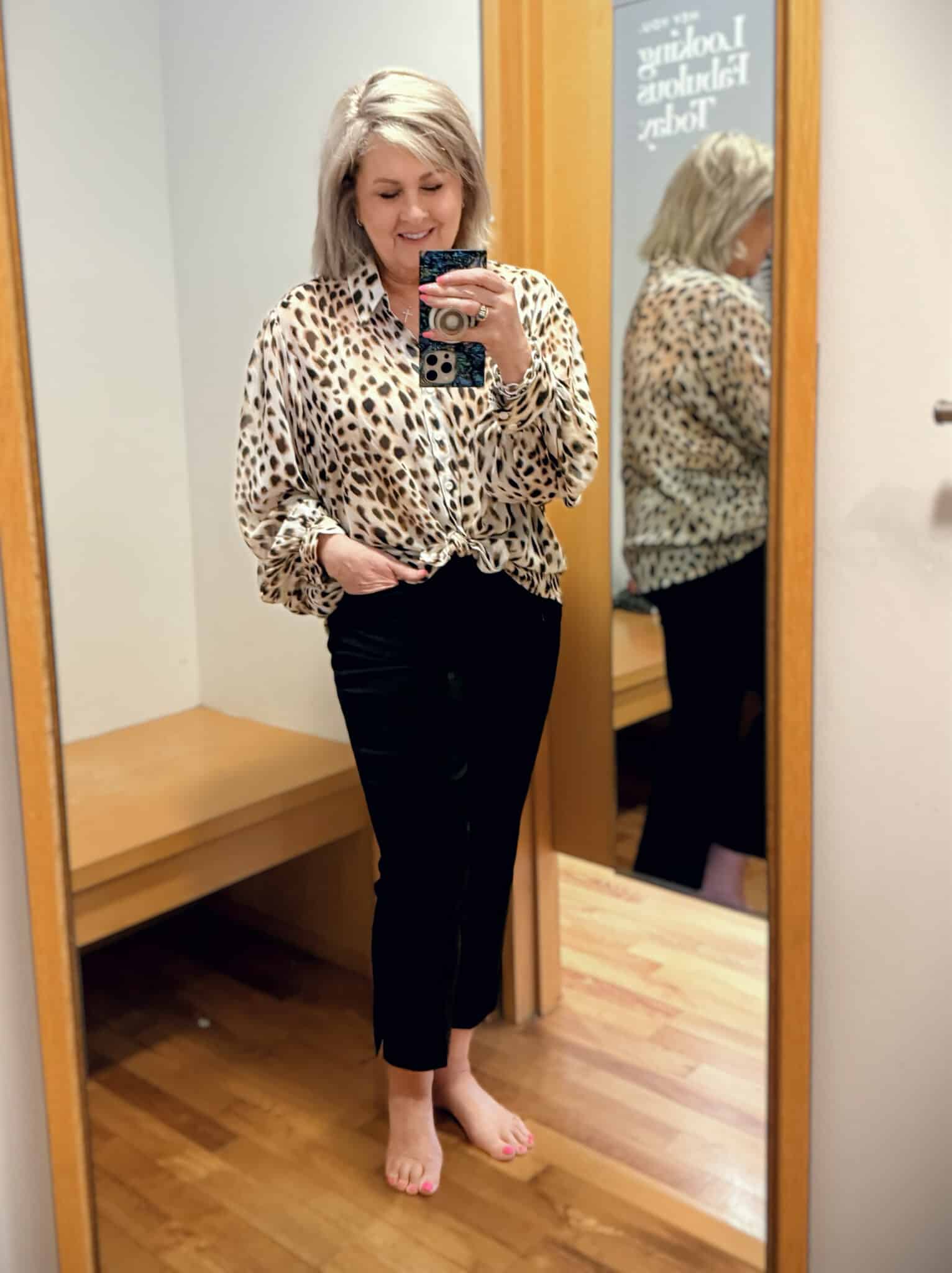 Tania wearing a sheer leopard print top with black pants from Chicos