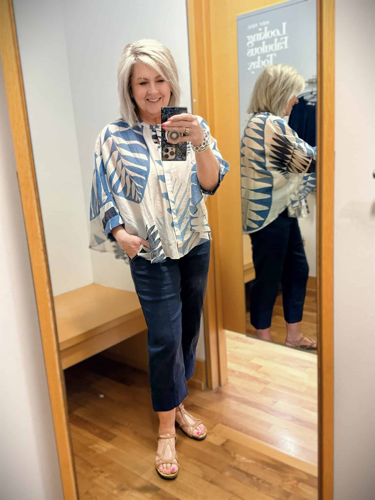 Tania wearing a blue poncho top with linen cropped pants from Chicos