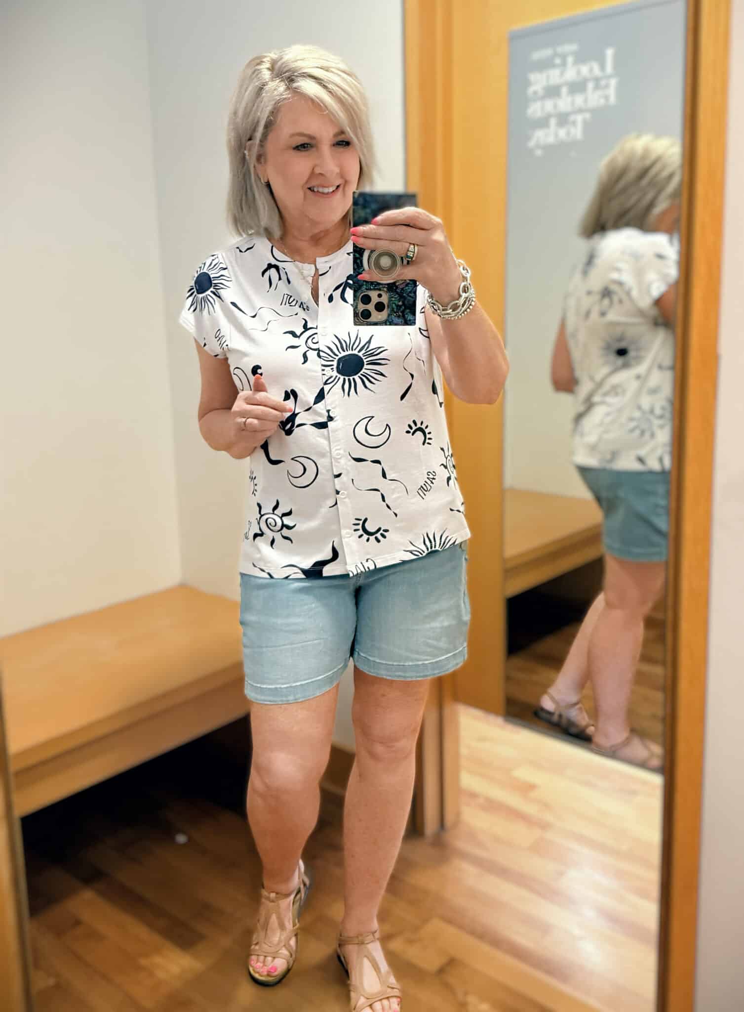 Tania wearing a white and blue top with scalloped shorts from Chicos
