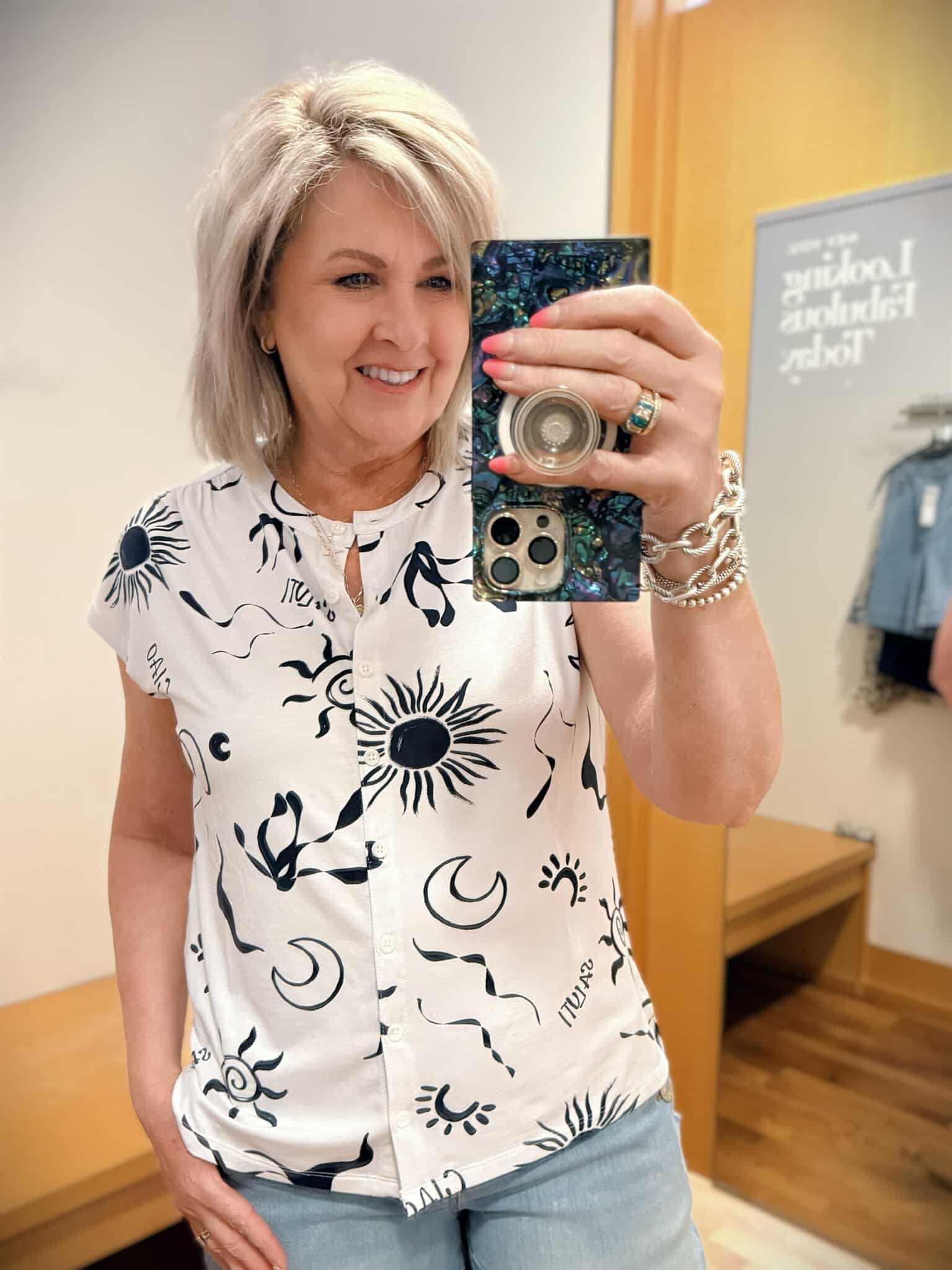Tania wearing a white and blue top from Chicos