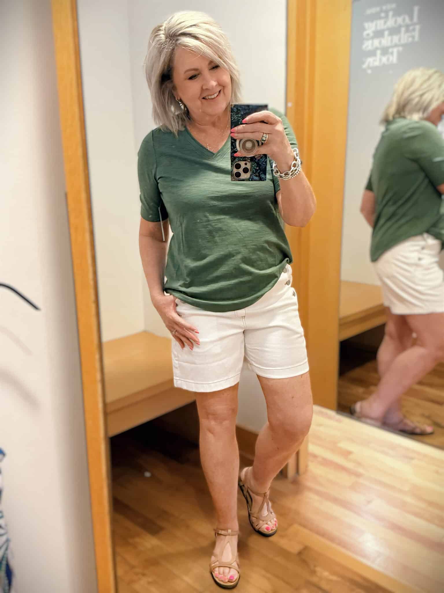 Tania wearing an olive colored tee with white scalloped shorts from Chicos