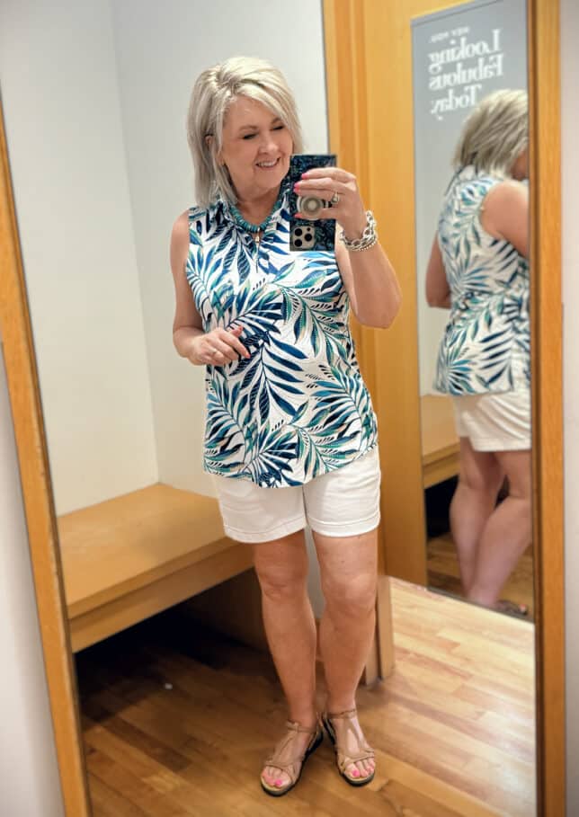 Tania wearing a sleeveless top on a palm print with white scalloped shorts from Chicos