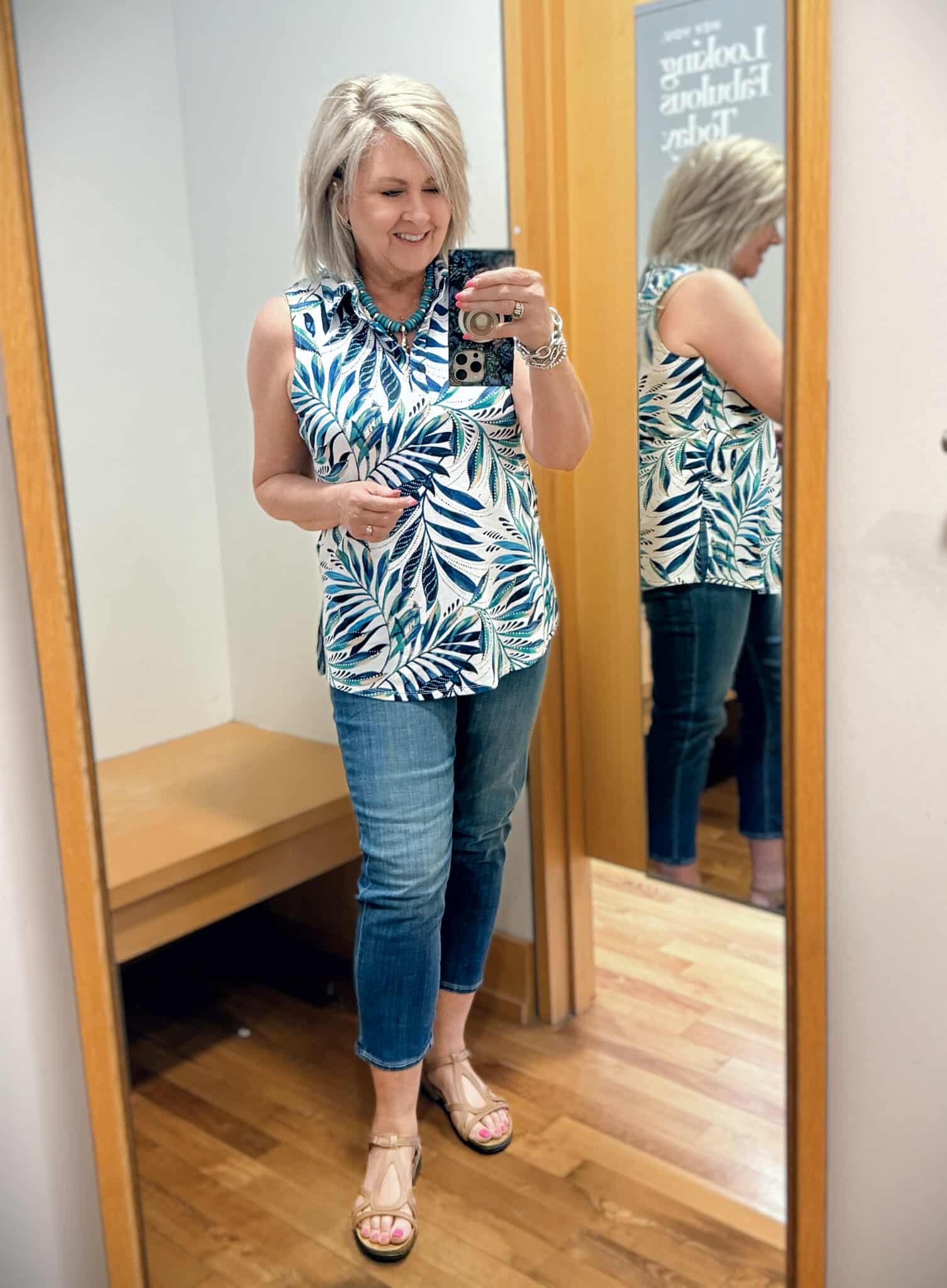 Tania wearing a sleeveless top on a palm print with girlfriend jeans from Chicos