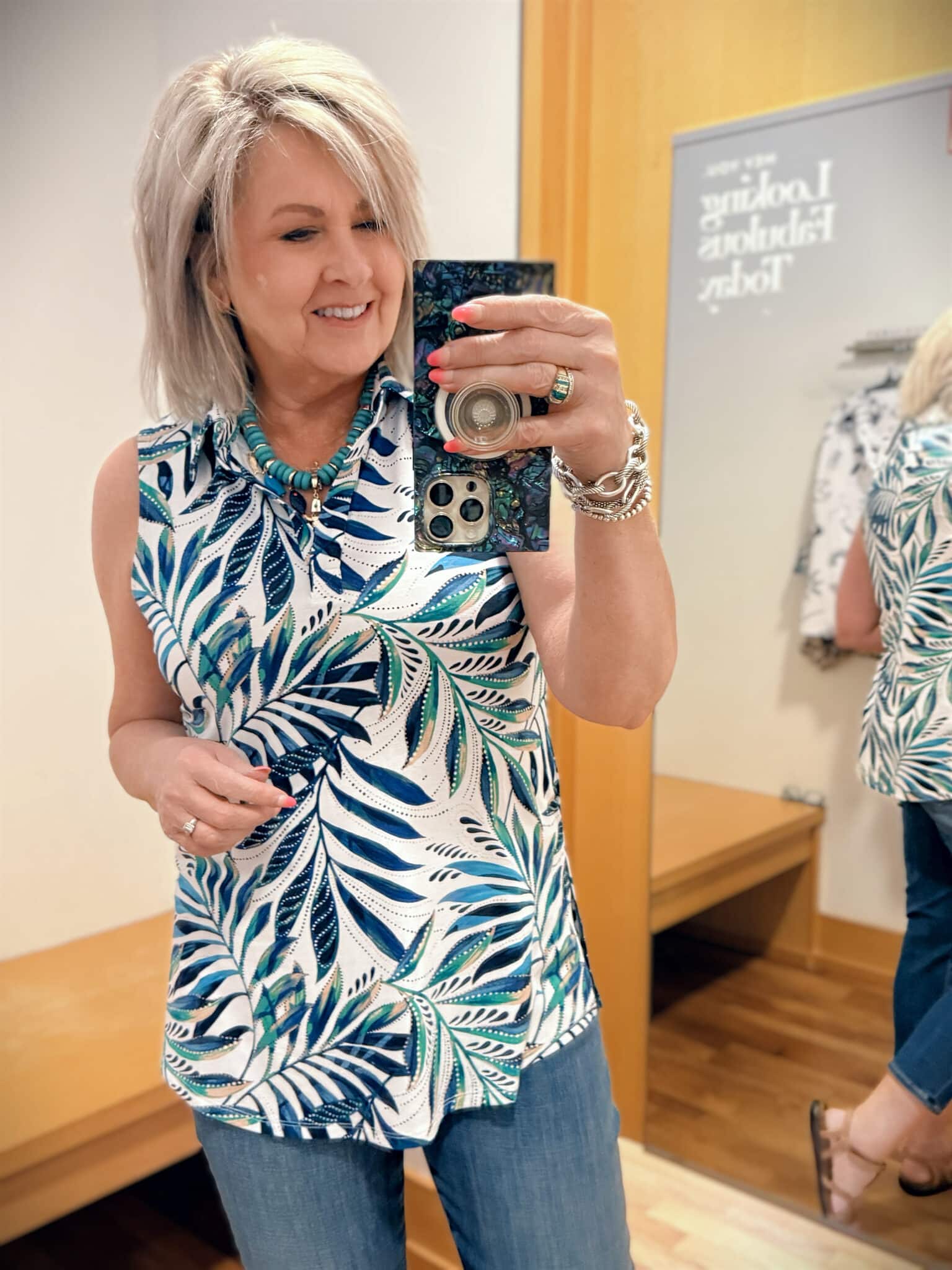 Tania wearing a sleeveless top on a palm print from Chicos