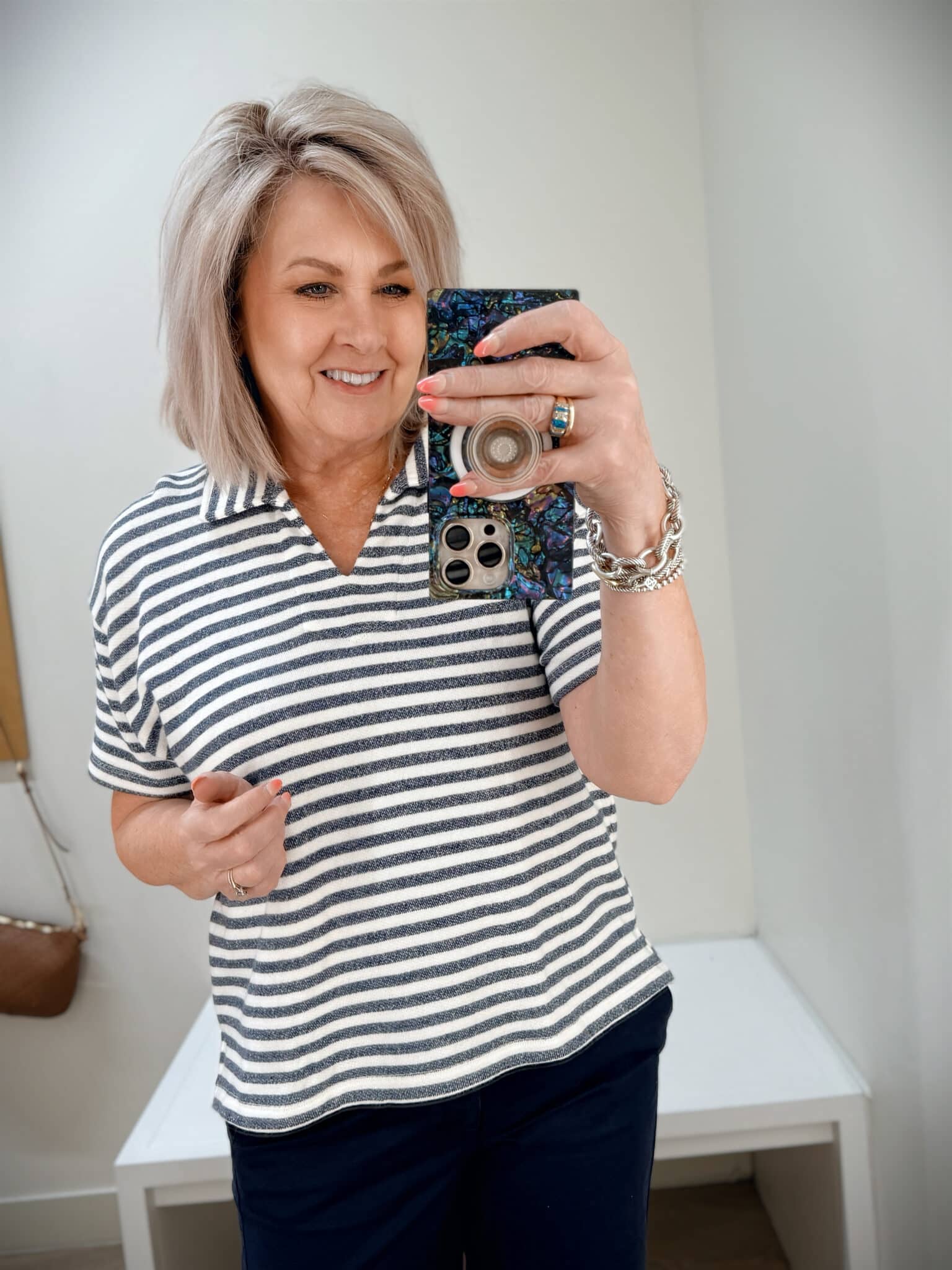 Tania wearing a striped v-neck collared top from J.Crew Factory