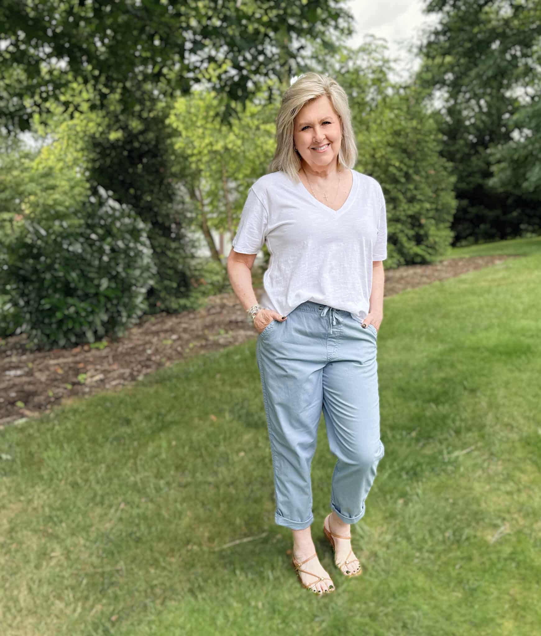 Tania is wearing a white V-neck tee with blueish relaxed chino pants from Kohl's
