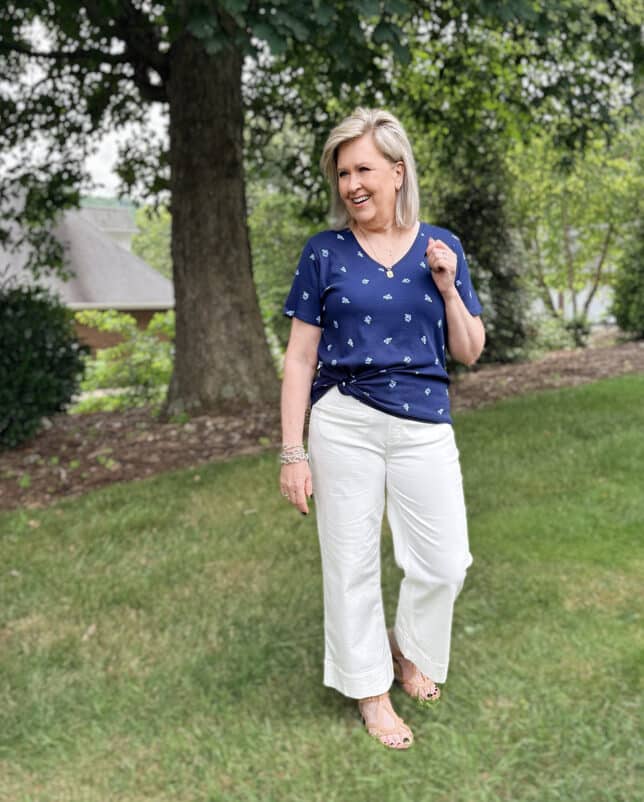 Tania is wearing a navy tee with floral white patch pocket jeans from Kohl's