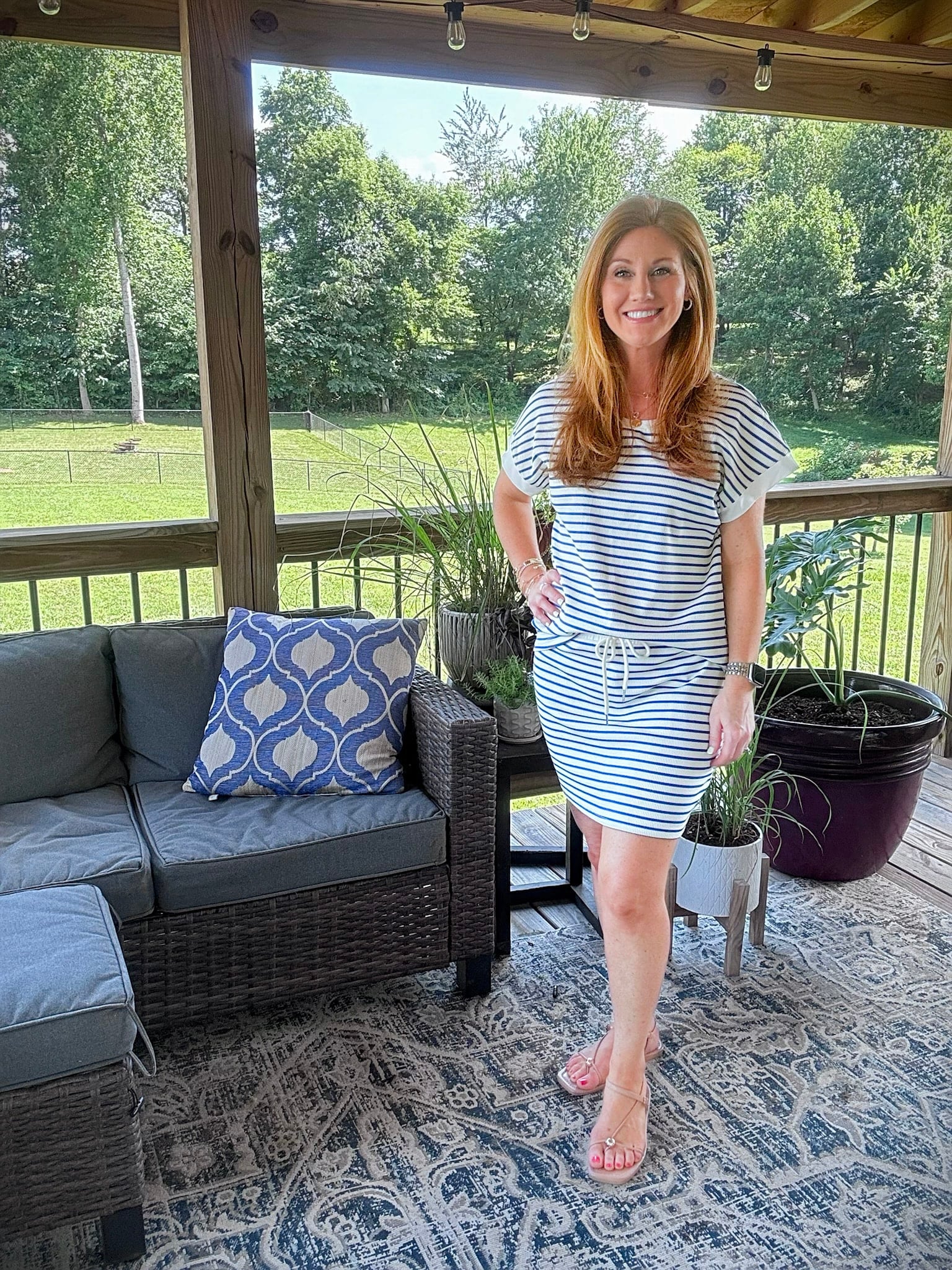 Petite woman wearing a blue and white striped two-piece skirt set from Amazon